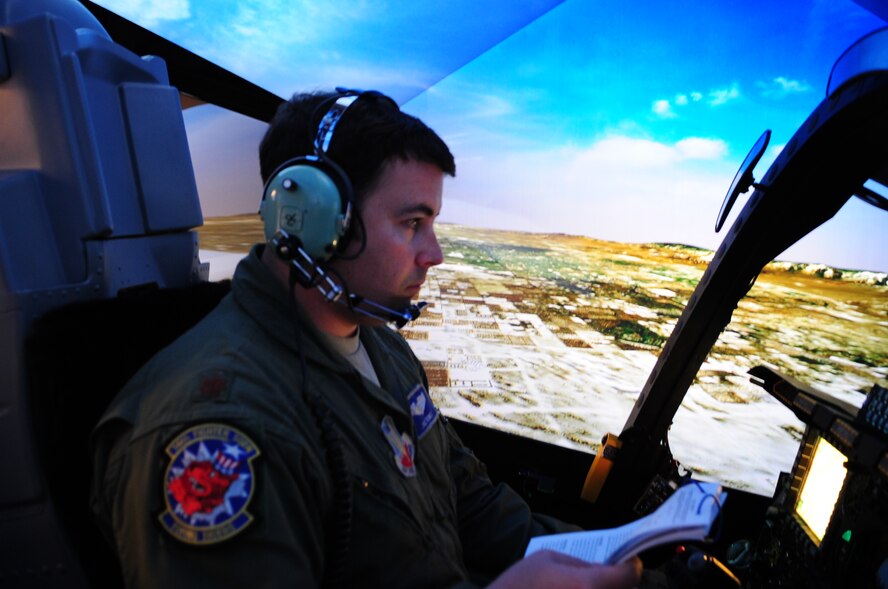 MOODY AIR FORCE BASE, Ga.-- Maj. Joseph Runci, 74th Fighter Squadron A-10C Thunderbolt II pilot, navigates unfamiliar terrain Nov. 22, inside the Full Mission Trainer, an A-10 cockpit simulator, used to familiarize pilots with the region they will be deployed to. Major Runci was flying over virtual Nevada where Green Flag West 11-02 is scheduled to run from Dec. 4 to 10. Green Flag is geared toward the current ground fight and the Air Force partnership with ground forces. (U.S. Air Force photo/Senior Airman Stephanie Longoria)(RELEASED)
