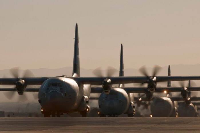 NELLIS AIR FORCE BASE, Nev.--  U.S. Air Force C-130 Hercules aircraft taxi down the Nellis runway after a Mobility Air Forces Exercise Nov 17. More than 40 C-17 Globemaster III and C-130 Hercules cargo aircraft assembled in aerial formations over the Nevada Test and Training Range to conduct air and ground operations as part of the bi-annual U.S. Air Force Weapons School MAFEX. (U.S. Air Force photo by Tech. Sgt. Michael R. Holzworth)