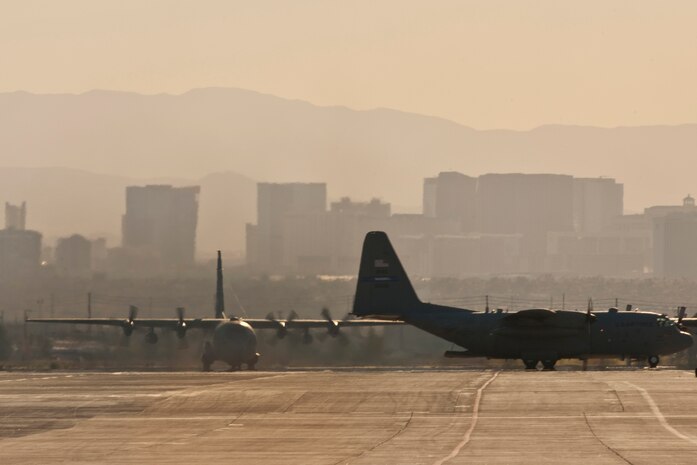 NELLIS AIR FORCE BASE, Nev. --  U.S. Air Force C-130 Hercules aircraft taxi in after a Mobility Air Forces Exercise held at the Nevada Test and Training Range,  Nov 17. Approximately 40 C-17 Globemaster and C-130 Hercules cargo aircraft will assemble in aerial formations over the NTTR to conduct air and ground operations as part of the bi-annual, U.S. Air Force Weapons School Mobility Air Forces Exercise.  (U.S. Air Force photo by Tech. Sgt. Michael R. Holzworth)(Released)