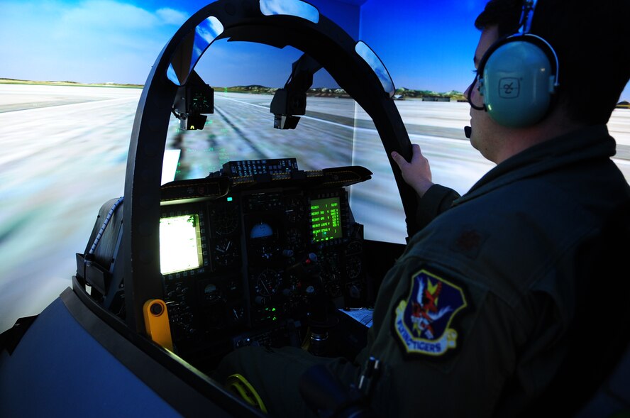 MOODY AIR FORCE BASE, Ga.-- Maj. Joseph Runci, 74th Fighter Squadron A-10C Thunderbolt II pilot, prepares for takeoff inside the Full Mission Trainer, an A-10 cockpit simulator, as part of the squadron’s preparation for Green Flag West 11-02 Nov. 22. The exercise is one of the Air Force's premiere pre-deployment exercises involving Air Combat Command flying units that perform close-air support and precision-guided munitions delivery. (U.S. Air Force photo/Senior Airman Stephanie Longoria)(RELEASED)
