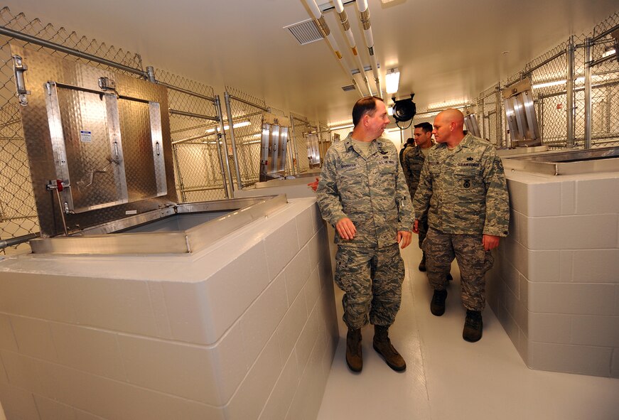 OFFUTT AIR FORCE BASE, Neb. - Tech. Sgt. Anthony Pevestorf, military working dog handler with the 55th Security Forces Squadron, escorts Brig. Gen. John N.T. Shanahan around the newly renovated dog kennels, Nov. 18.  The $1.3 million renovation comes well equipped giving the dogs a 10 foot by 14 foot space with private dog house, heated floors, separate isolation kennels for sick dogs and other medical treatment among many other modern amenities. The 55 SFS K-9 section is responsible for searching over 3,000 vehicles a year, securing 54,000 people, protecting and $9 billion in assets.U.S. Air Force photo by Josh Plueger
