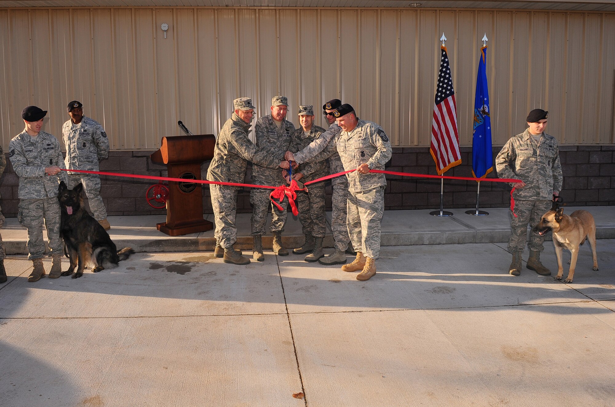 OFFUTT AIR FORCE BASE, Neb. ? Brig. Gen. John N.T. Shanahan, 55th Wing commander, and other Offutt leaders perform the formal ribbon cutting of the newly renovated dog kennels Nov. 18.  The $1.3 million renovation comes well equipped giving the dogs a 10 foot by 14 foot space with private dog house, heated floors, separate isolation kennels for sick dogs and other medical treatment among many other modern amenities.  The 55th Security Forces K-9 section is responsible for searching over 3,000 vehicles a year, securing 54,000 people, protecting and $9 billion in assets.
U.S. Air Force photo by Josh Plueger
