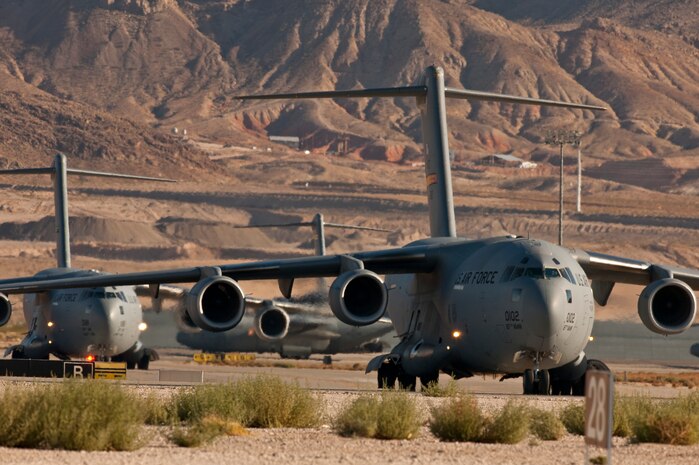 NELLIS AIR FORCE BASE, Nev. --  C-17 Globemaster III's Line up on the Nellis taxiway during the Mobility Air Forces Exercise held at Nellis and the Nevada Test and Training Range,  Nov 17. Approximately 40 C-17 Globemaster III and C-130 Hercules cargo aircraft will assemble in aerial formations over the NTTR to conduct air and ground operations as part of the bi-annual, U.S. Air Force Weapons School Mobility Air Forces Exercise.  (U.S. Air Force photo by Tech. Sgt. Michael R. Holzworth)(Released)