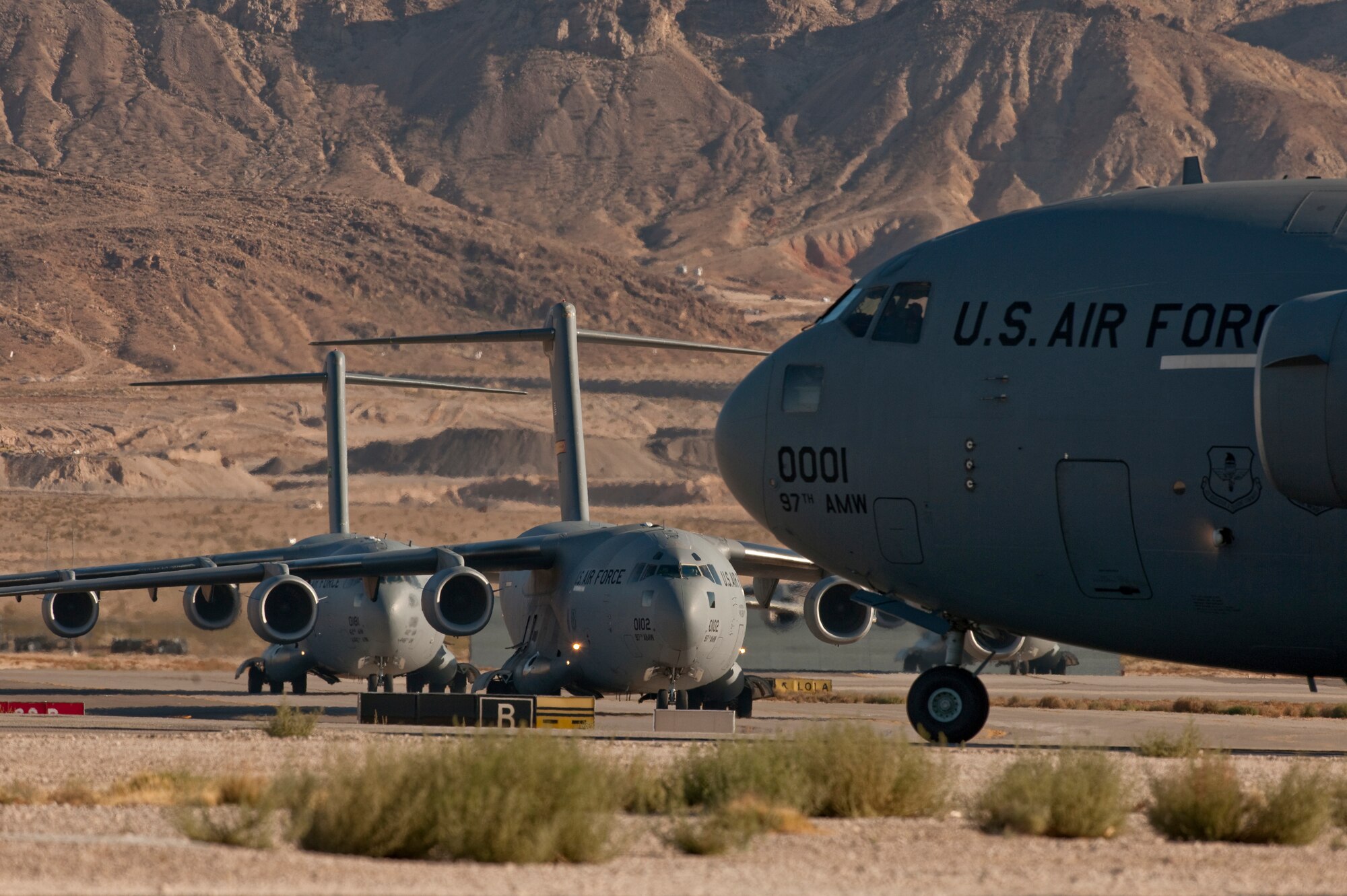 NELLIS AIR FORCE BASE, Nev. --  C-17 Globemaster III's line up on the Nellis taxiway during the Mobility Air Forces Exercise Nov 17. More than 40 C-17 Globemaster III and C-130 Hercules cargo aircraft assembled in aerial formations over the Nevada Test and Training Range to conduct air and ground operations as part of the bi-annual U.S. Air Force Weapons School MAFEX. (U.S. Air Force photo by Tech. Sgt. Michael R. Holzworth)