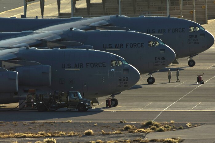 NELLIS AIR FORCE BASE, Nev. --  Three C-17 Globemaster III aircraft line up on the Nellis taxiway during the Mobility Air Forces Exercise Nov 17. More than 40 C-17 Globemaster III and C-130 Hercules cargo aircraft assembled in aerial formations over the Nevada Test and Training Range to conduct air and ground operations as part of the bi-annual U.S. Air Force Weapons School MAFEX. (U.S. Air Force photo by Airman 1st Class Jamie Nicley)