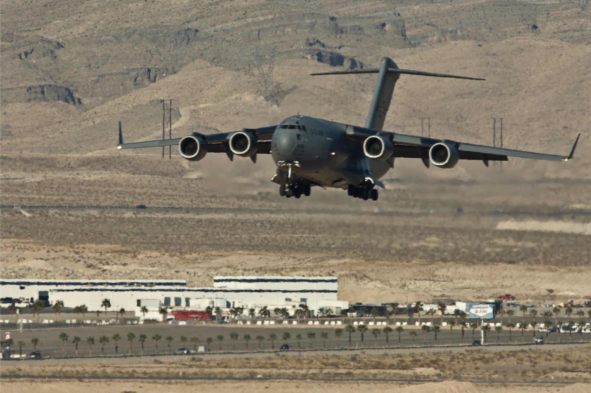 NELLIS AIR FORCE BASE, Nev.-- A C-17 Globemaster III aircraft prepares to land on the Nellis runway during the Mobility Air Forces Exercise Nov 17. More than 40 C-17 Globemaster III and C-130 Hercules cargo aircraft assembled in aerial formations over the Nevada Test and Training Range to conduct air and ground operations as part of the bi-annual U.S. Air Force Weapons School MAFEX. (U.S. Air Force photo by Airman 1st Class Jamie Nicley)