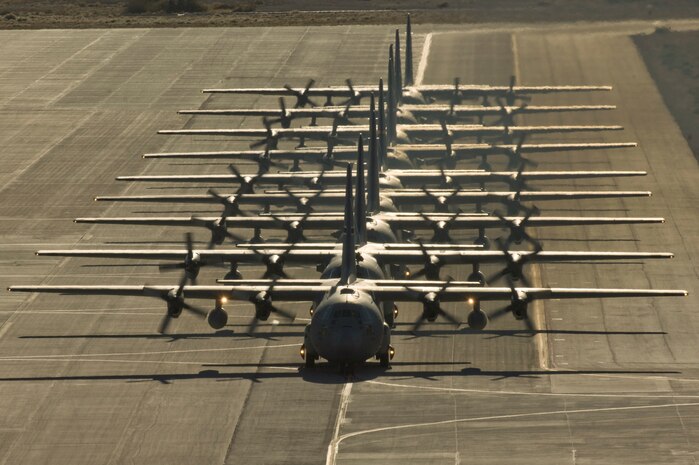NELLIS AIR FORCE BASE, Nev.--  Nine C-130 Hercules aircraft line up on the Nellis runway during the Mobility Air Forces Exercise Nov. 17.  More than 40 C-17 Globemaster III and C-130 Hercules cargo aircraft assembled in aerial formations over the Nevada Test and Training Range to conduct air and ground operations as part of the bi-annual U.S. Air Force Weapons School MAFEX. (U.S. Air Force photo by Airman 1st Class Jamie Nicley)