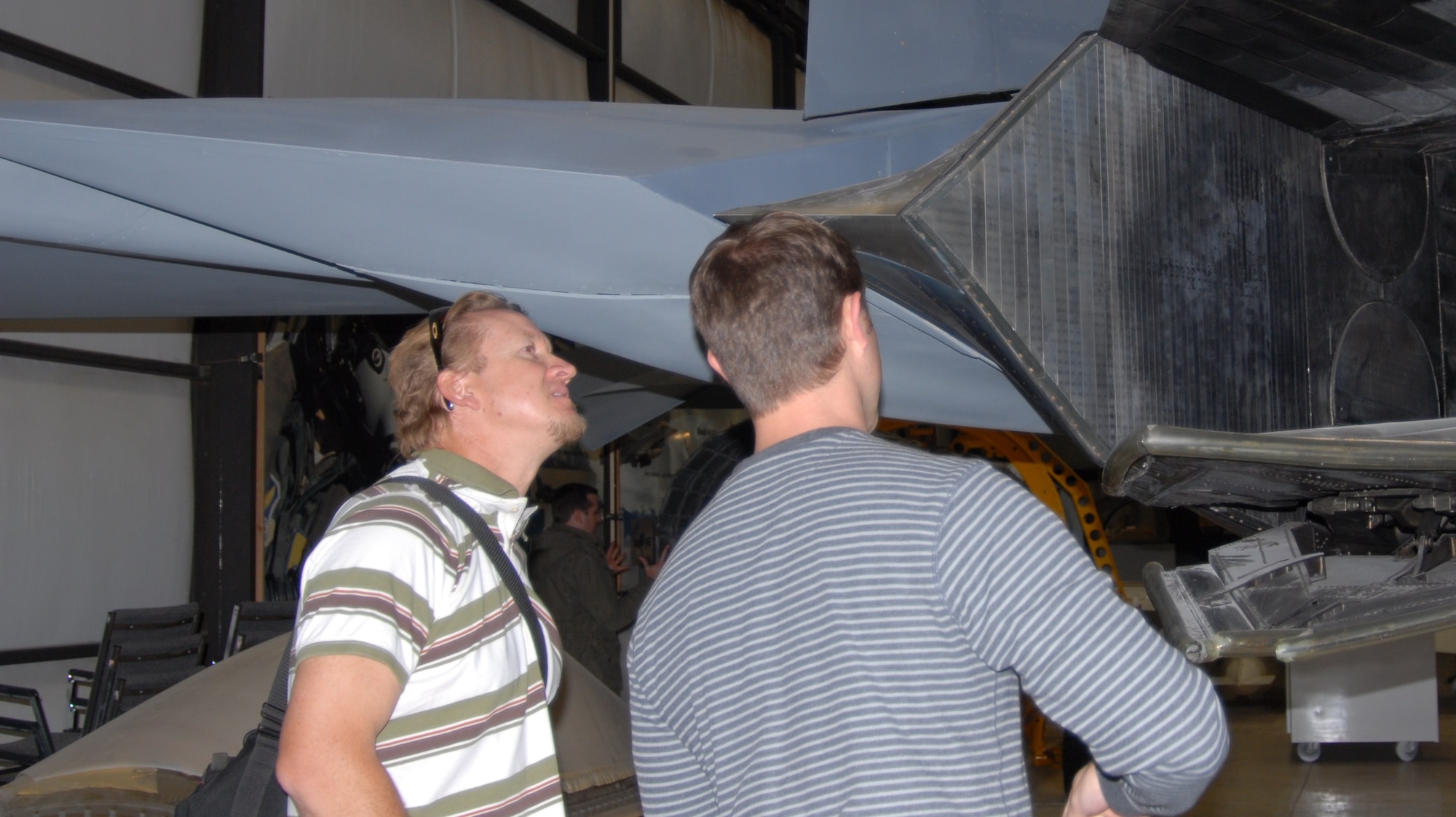 Kevin Nelson (left) and Andy Harkness (right), Walt Disney animators, observe the shape and details on the YF-22 aircraft located in the Air Force Flight Test Center Museum. A group of nine Disney artists toured the base to conduct developmental research on a possible feature film idea, Nov. 18. (Air Force Photo by Kate Blais)