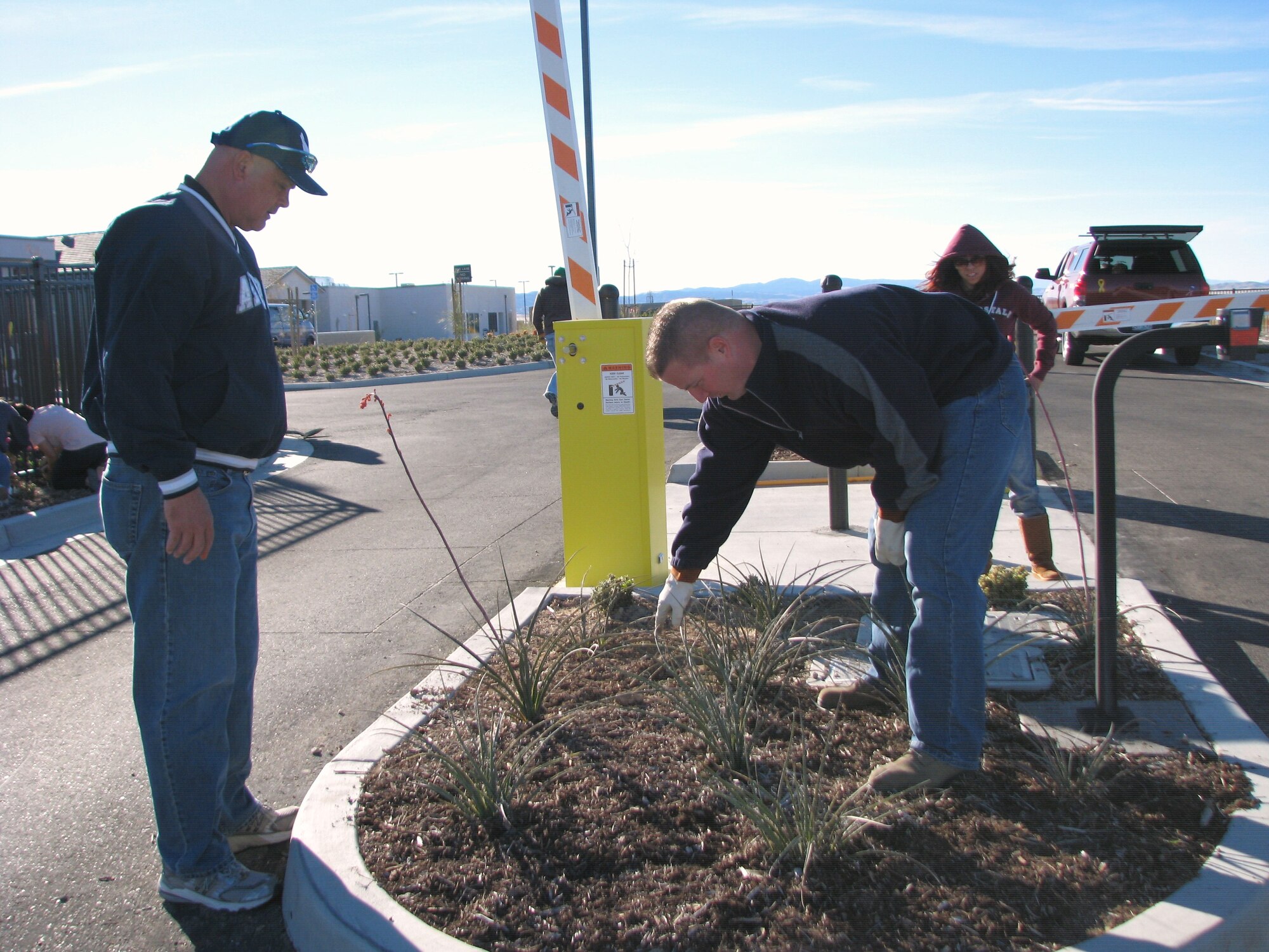 Chief Master Sgt. David Gilmore, 95th Medical Group (left), helps Master Sgt. Dave Holzer, 31st Test and Evaluation Squadron, with a design plan for placing the 400 plants and flowers Edwards Airmen planted at the William J. "Pete" Knight Veterans Home in Lancaster, Calif., on Veterans Day, Nov. 11. (Air Force photo by Diane Betzler)
