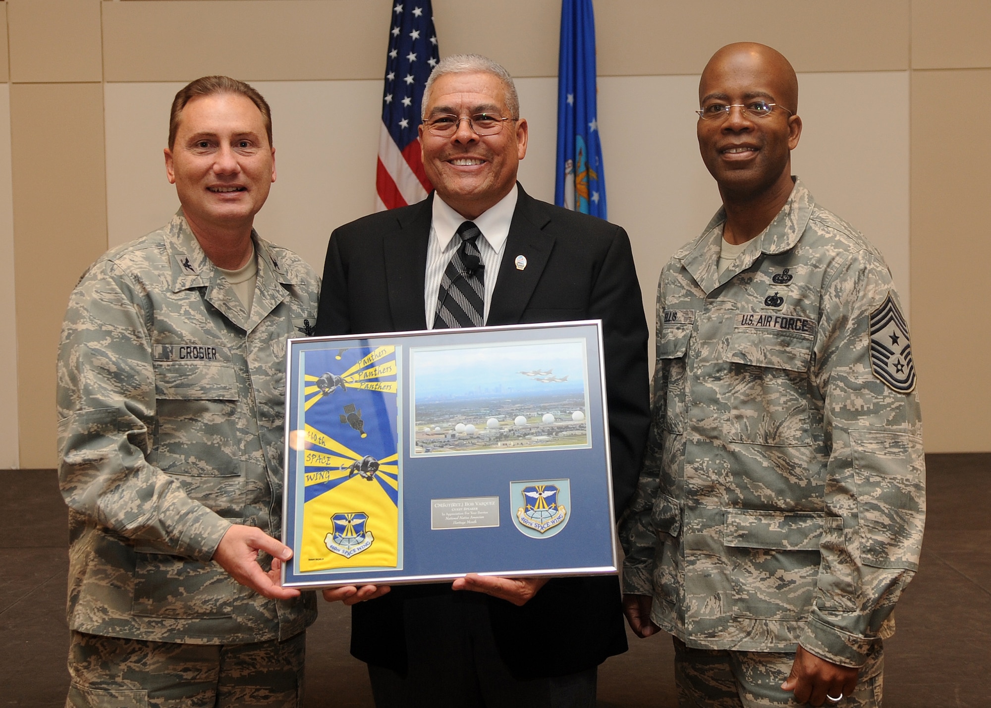 Buckley Air Force Base, Colo.-  Colonel Clinton Crosier and Chief Master Sgt. Robert Ellis present Chief Master Sgt (Ret.) Bob Vasquez with an honorary plaque. CMSgt Vasquez was guest speaker for Buckley's Native American Heritage celebration. ( U.S. Air Force Photo by Airman 1st Class Marcy Glass )
