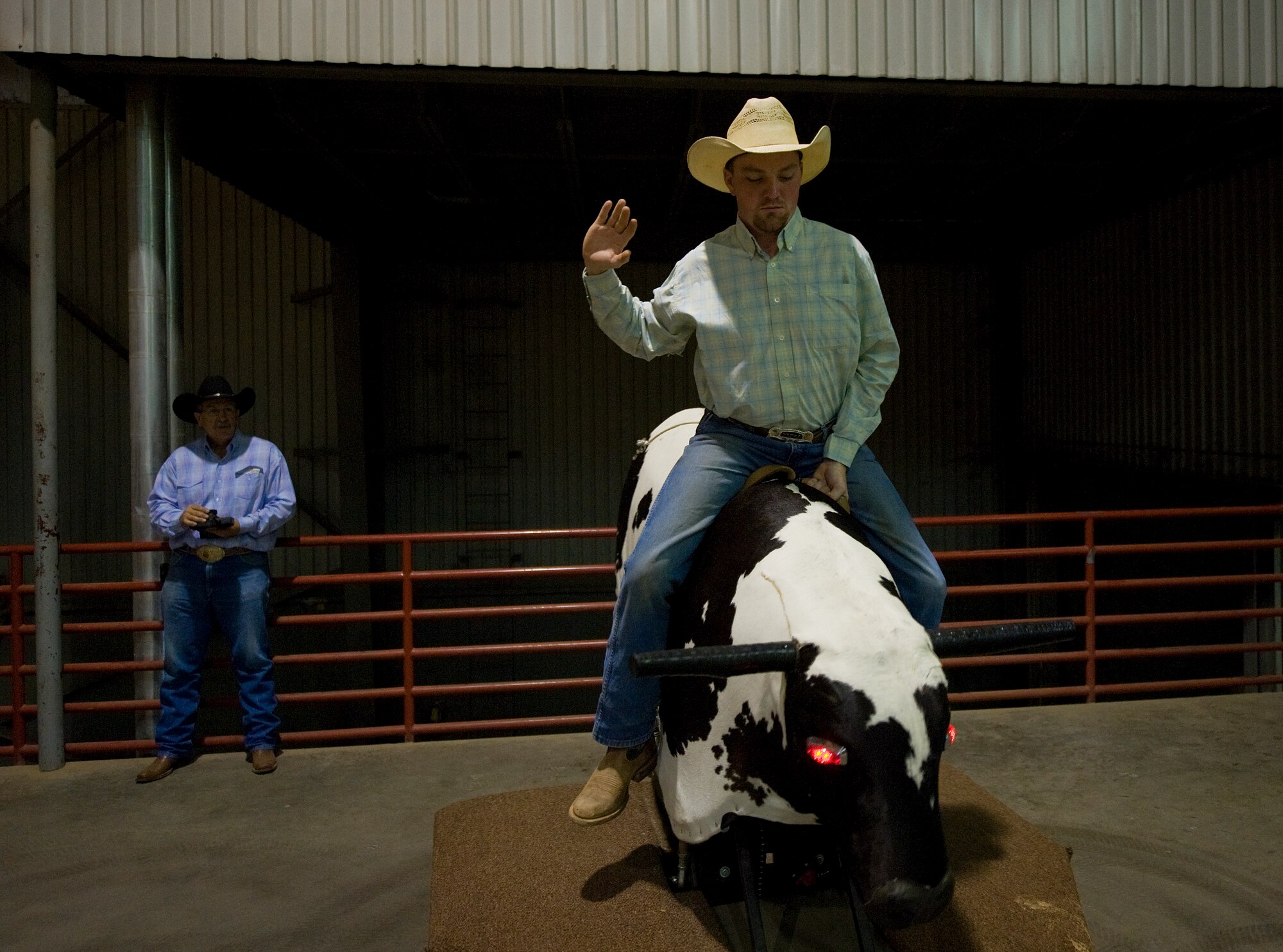 Master Sgt. R.J. Eppers practices for the bull riding competition using Robo Bull a remote controlled bull riding simulator at the Professional Armed Forces Rodeo Associations World Finals Nov. 20, 2010, in Glen Rose, Texas. (U.S. Air Force photo/Tech. Sgt. Bennie J. Davis III)