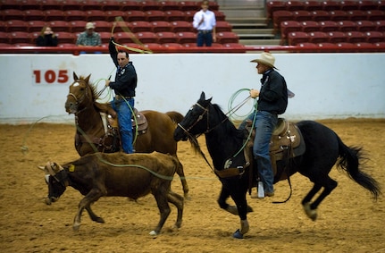 Tech. Sgt. Devin Fisher and Master Sgt. Travis Beck friends and teammates compete together during the team roping competition at the Professional Armed Forces Rodeo Associations World Finals Nov. 20, 2010, in Glen Rose, Texas. Sergeant Beck earned first place in the Men's All-Around taking top honors of the rodeo and Tech. Sgt. Fisher earned Rookie of the Year. (U.S. Air Force photo/Tech. Sgt. Bennie J. Davis III)
