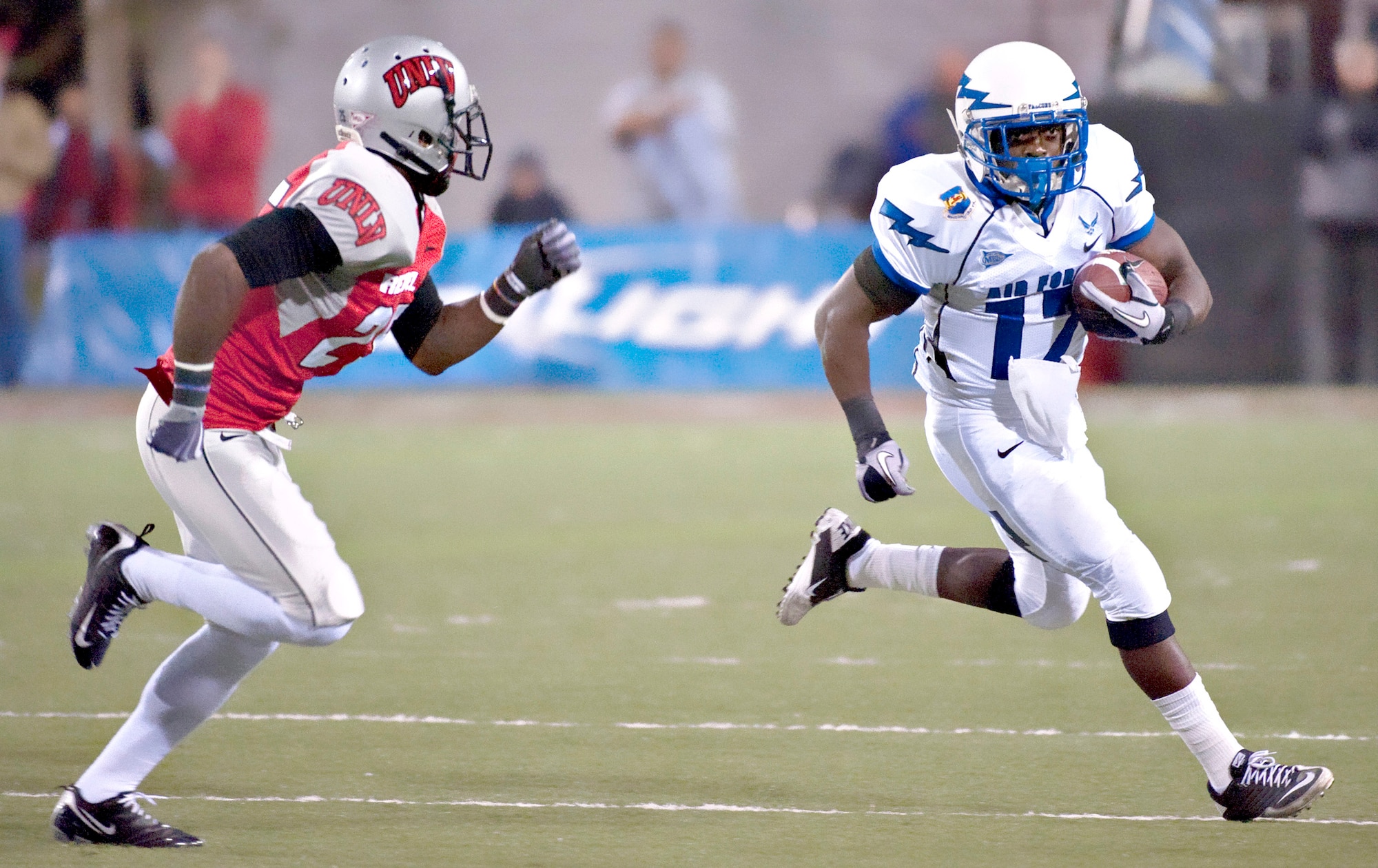 Air Force running back Asher Clark runs left during the Falcons' match against the University of Nevada, Las Vegas Nov. 18, 2010, in Las Vegas. Clark had 14 rushes and 82 yards, which puts him over 1,000 yards for the season. The Falcons defeated the Rebels 35-20 in their final regular-season game, improving their record to 8-4. (U.S. Air Force photo/Tech. Sgt. Michael R. Holzworth)