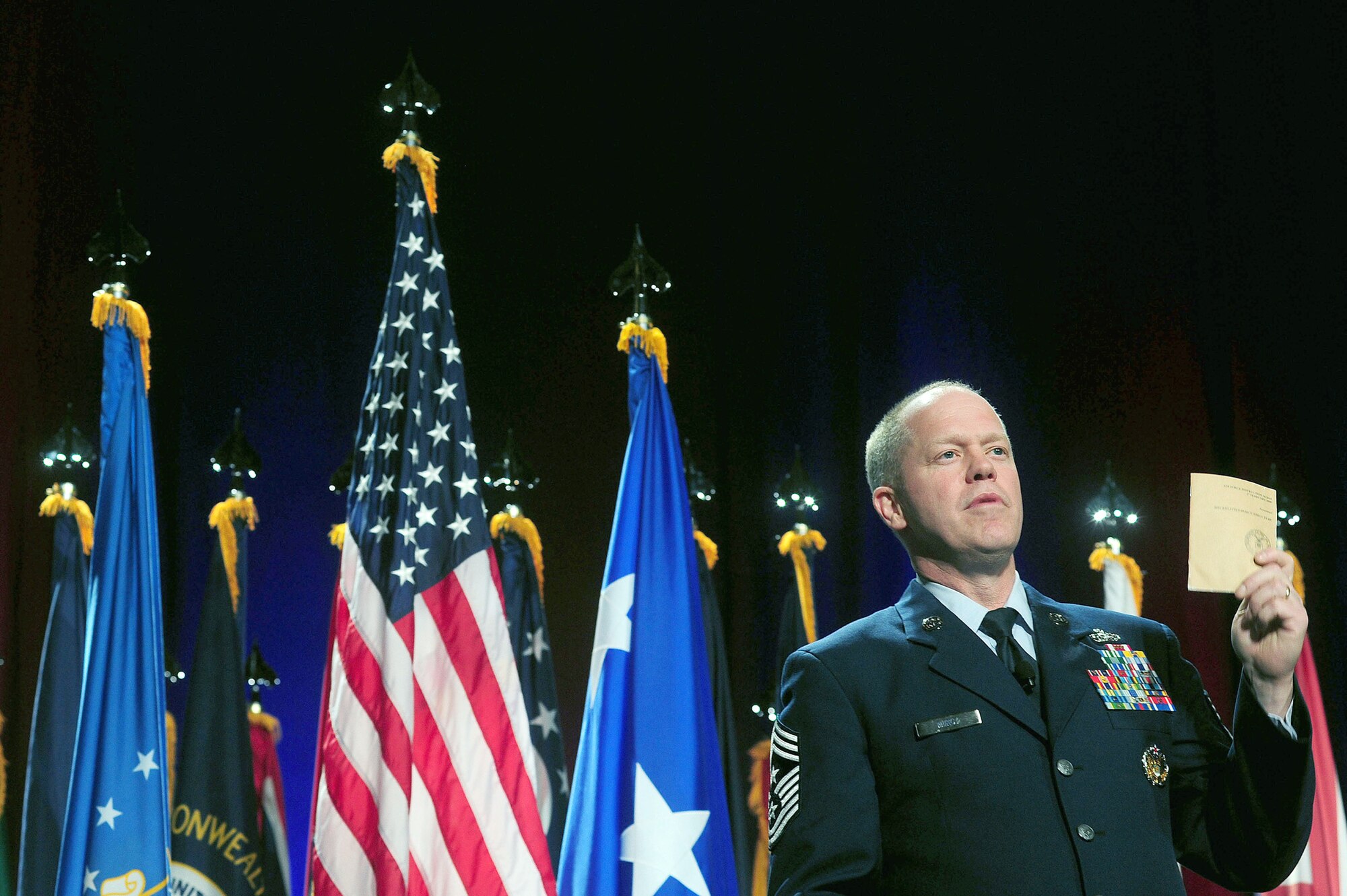 Air National Guard Command Chief Master Sgt. Christopher Muncy holds up a copy of the Air Force's "Enlisted Force Structure Handbook," while addressing attendees at the Air National Guard's Senior Leadership Conference Nov. 18, 2010, in Washington, D.C. Chief Muncy stressed the importance of using the handbook to develop junior Airmen into NCOs and leaders. (U.S. Army photo by Sgt. 1st Class Jon Soucy)
