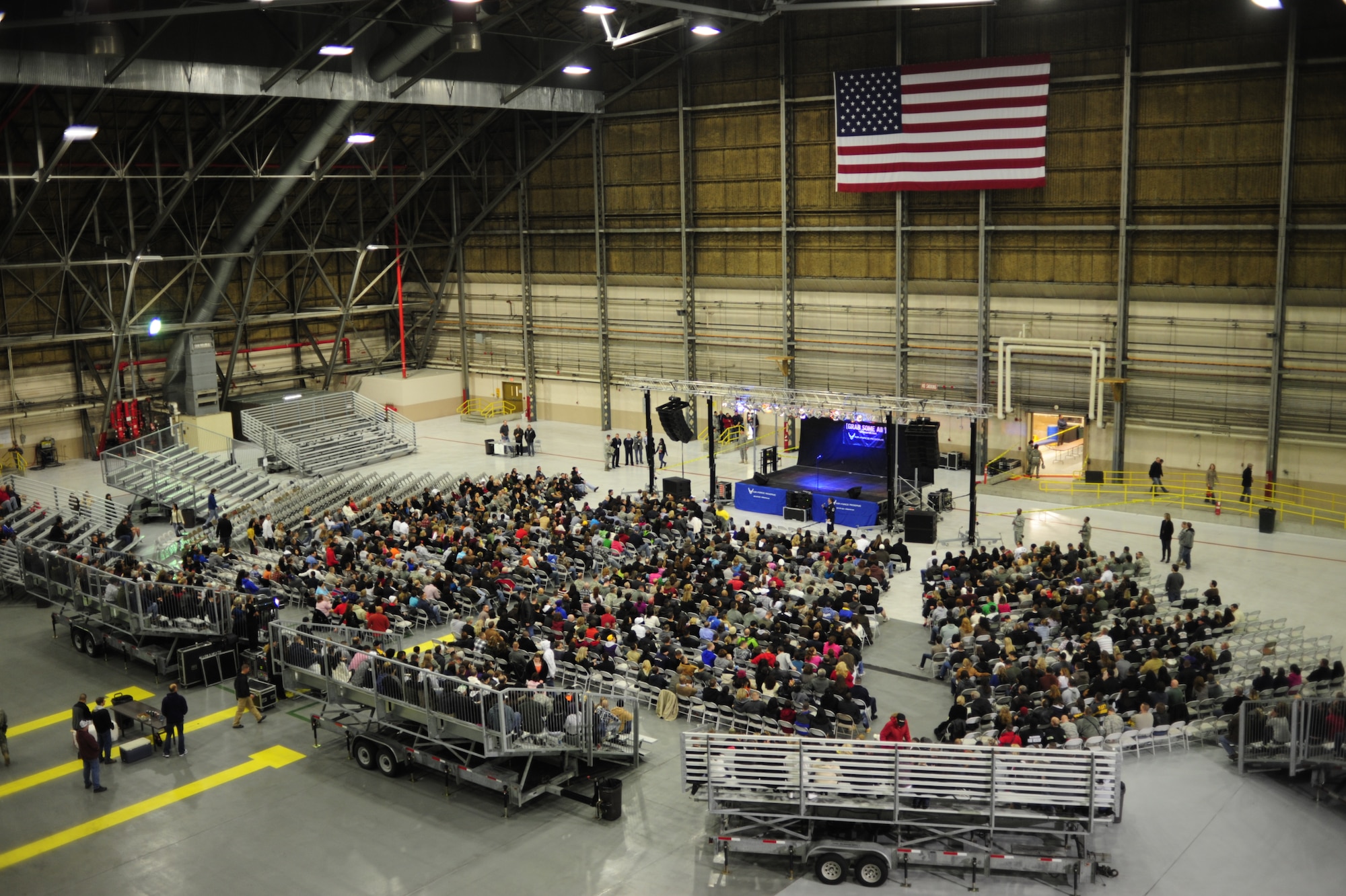 The crowd of more than 2,000 fans find their seats in preparation for the comedic performance of Carlos Mencia, the man behind Comedy Central's popular "Mind of Mencia" television program, Nov. 19. at McChord Field, Joint Base Lewis-McChord, Wash. (U.S. Air Force photo/Airman Leah Young)