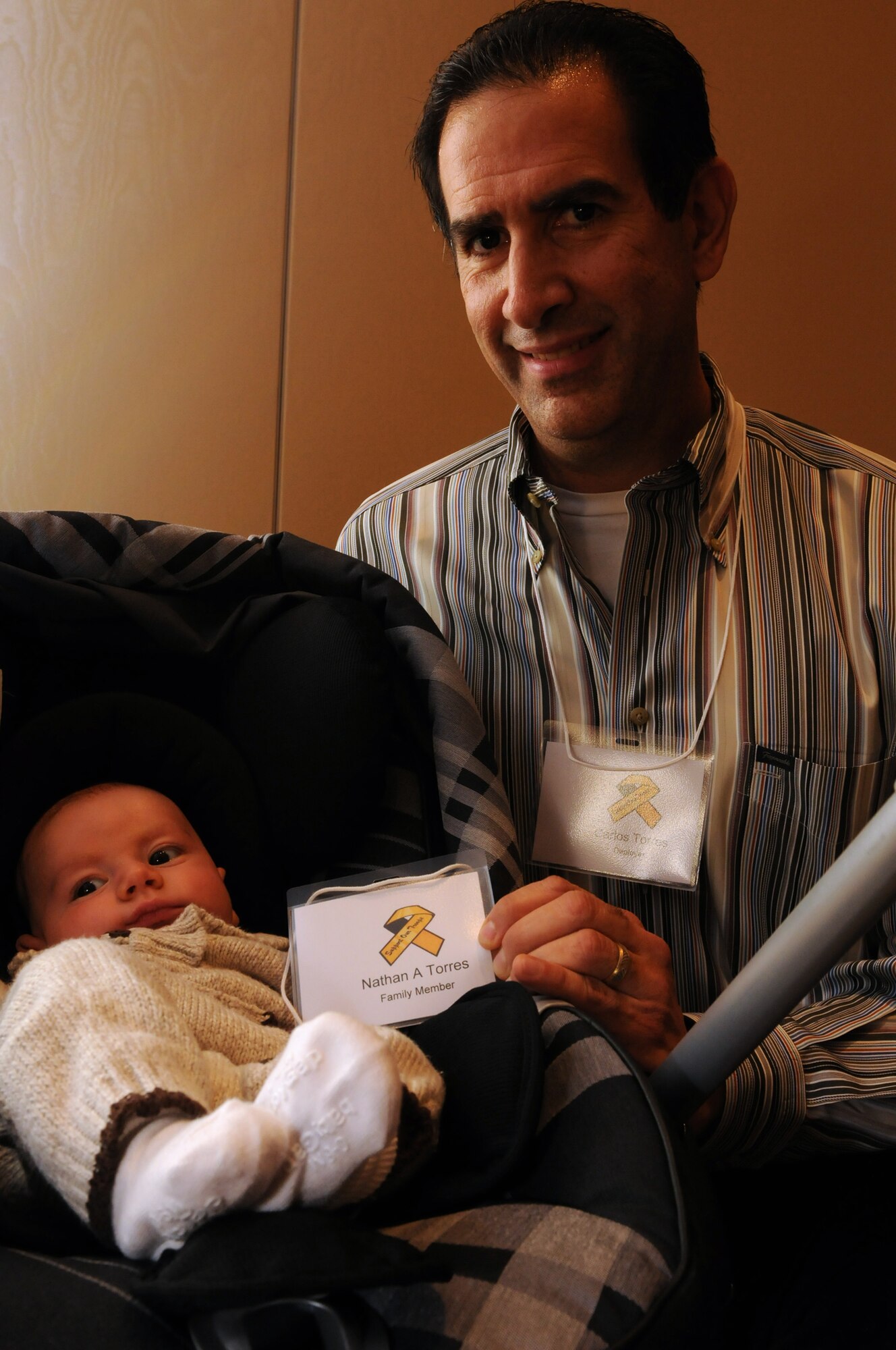 NATIONAL HARBOR, Md. -- Master Sgt. Carlos Torres, 459th Maintenance Group, and his son, Nathan, enjoy an afternoon lunch during the Yellow Ribbon event at the Gaylord National Hotel and Convention Center, Nov. 19-21. Sergeant Torres joined fellow Airmen who recently returned from deployments in attending the three-day event, which provided them with information on reintegrating back into civilian and family life. (U.S. Air Force photo/Tech. Sgt. Steve Lewis)