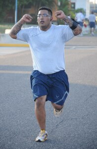SOTO CANO AIR BASE, Honduras --  Crossing the finish line, Staff Sgt. Mike Reyes, of Army Forces here, completes the Turkey Trot here Nov. 22. The run was sponsored by the Morale, Welfare and Recreation office here. (U.S. Air Force photo/Tech. Sgt. Benjamin Rojek)