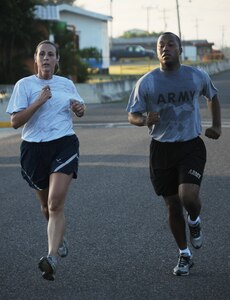 SOTO CANO AIR BASE, Honduras --  Pacing each other to the finish line, Air Force Capt. Emily Lewis, left, the Joint Task Force-Bravo protocol officer, and Army SPC Jahari Dumas, a JTF-B Command Group assistant, run in the Turkey Trot here Nov. 22. The run was sponsored by the base Morale, Welfare and Recreation office. (U.S. Air Force photo/Tech. Sgt. Benjamin Rojek)