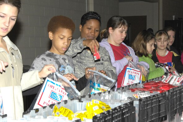 Volunteers fill care packages for deployed military members during the Troop Care Drive Nov. 20 in Hanscom's snow barn. More than 220 people turned out to lend a hand in packing 10,275 care packages during the event, which was sponsored by the USO and Lockheed Martin. (U.S. Air Force photo by Linda Labonte Britt) 

