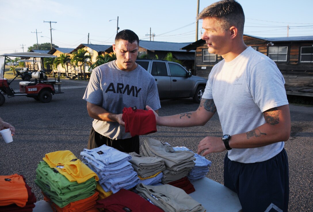 SOTO CANO AIR BASE, Honduras --  At the finish line, volunteers hand out Joint Task Force-Bravo Turkey Trot T-shirts here Nov. 22. The first 150 runners to complete the Turkey Trot received a free shirt. The run was sponsored by the base Morale, Welfare and Recreation office. (U.S. Air Force photo/Tech. Sgt. Benjamin Rojek)