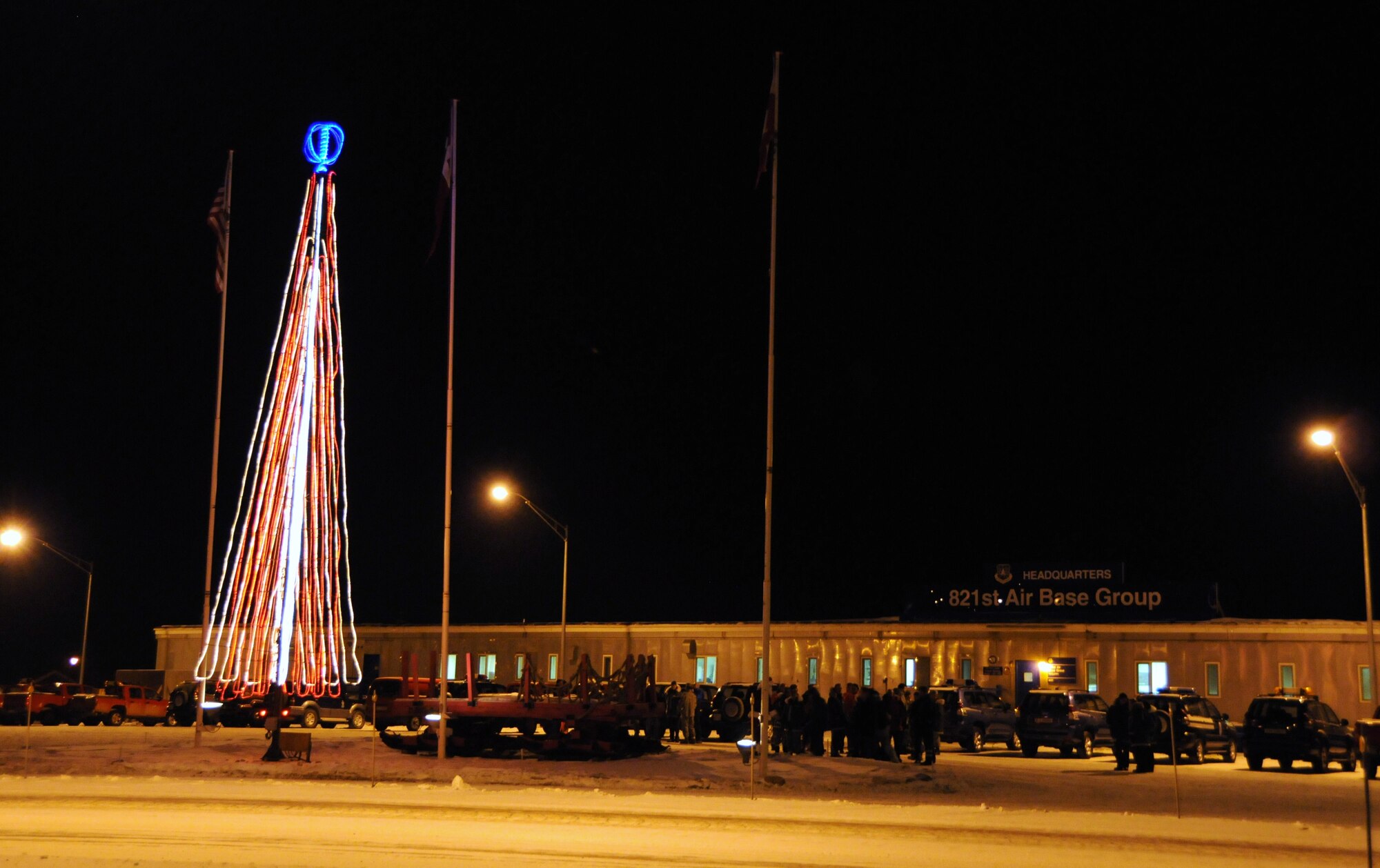 THULE AIR BASE, Greenland – Members of the 821st Air Base Group are the first to spark up the holiday season by lighting their Christmas tree of lights, fitting due to their proximity to the North Pole. Members also kicked off the season by wrapping presents that they will take to children of Qaanaaq, the nearest village to Thule Air Base. Santa is expected to fly in by helicopter in December, which is consistent with the Danish lore that Santa lives in Greenland, not the North Pole. Thule Air Base, one of the six installations supported by the 21st Space Wing, is the U.S. Armed Forces' northernmost installation, located 750 miles north of the Arctic Circle. (U.S. Air Force photo/Tech. Sgt. Claude Winfree)