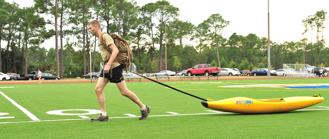Capt. Graydon Muller pulls a kayak across a field Oct. 28, 2010, at Hurlburt Field, Fla., to simulate pulling a supply sled in preparation for an upcoming mountaineering expedition to climb Vinson Massif, the highest mountain in Antarctica. Captain Muller and Capt. Rob Marshall, a member of the 8th Special Operations Squadron, depart Nov. 24, 2010, to climb the 16,076 foot mountain as part of the U.S. Air Force Seven Summits Challenge, an effort for Air Force members to climb the highest mountain on each continent. Captain Muller is a member of the 6th Special Operations Squadron at Hurlburt Field. (U.S. Air Force photo/Staff. Sgt. Stephanie Jacobs) 