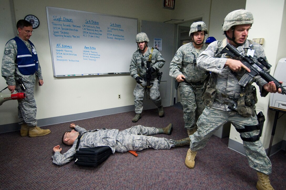 A group of 11th Security Forces Squadron members neutralize a disgruntled and mentally unstable Airman with a firearm after he attacked a group of unsuspecting Airmen at the 11th Comptroller Squadron during an ACTIVE SHOOTER EXERCISE Nov. 16. Approximately 23 casualties and 7 fatalities were tallied. Among the players involved in the coordination of the exercise were the 11th Wing, 11th Operations Group, Crisis Action Team, Emergency Operations Center, Joint Base Andrews Group and Unit Control Centers Headquarters Air Force District of Washington, 79th Medical Wing, 844th Communications Group, 744th Communications Squadron, 7th Field Investigations Squadron Office of Special Investigations, Naval District Washington, 459th Air Refueling Wing, 457th Airlift Squadron, and 113th Wing.  (U.S. Air Force photo/Bobby Jones)

