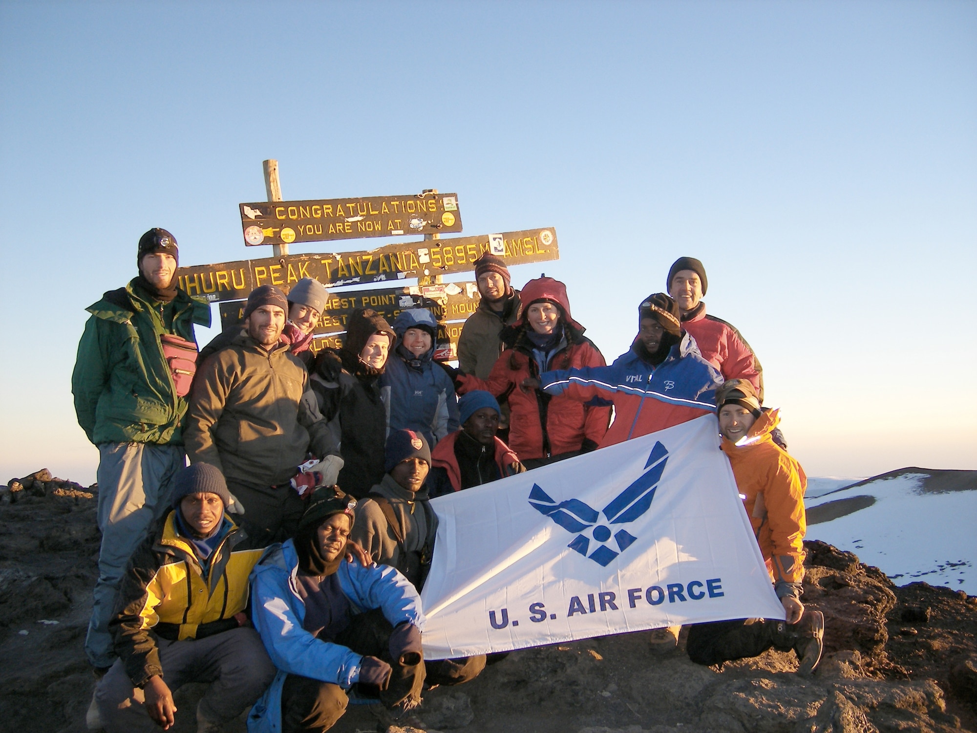 Capt. Graydon Muller (far left, standing), and Capt. Rob Marshall (far right, kneeling) pose at the summit of Mt. Kilimanjaro, the highest peak in Africa, as part of the U.S. Air Force Seven Summits Challenge in July 2006. The U.S. Air Force Seven Summits Challenge is an endeavor for Air Force members to carry the Air Force flag to the highest point on each continent and to be the first U.S. military group to conquer all seven peaks. Captains Muller and Marshall will depart Nov. 24, 2010 to attempt the group?s fifth summit, Vinson Massif in Antarctica. Captain Muller is a member of the 6th Special Operations Squadron. Captain Marshall is a member of the 8th Special Operations Squadron. (U.S. Air Force photo) 
