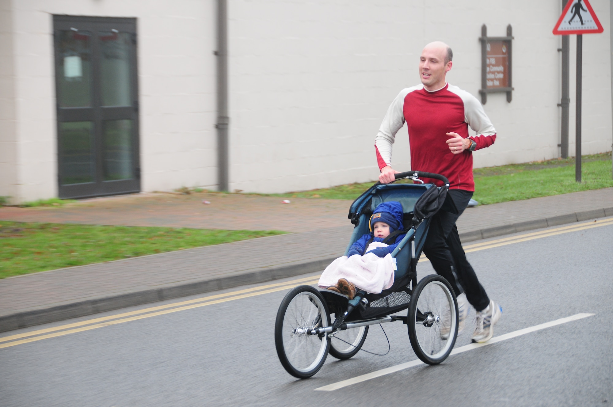 ROYAL AIR FORCE LAKENHEATH, England – Evan Riley, husband of Maj. Christa Riley, 48th Medical Surgical Squadron, pushes their son, Finn Riley, to the 2010 Turkey Trot finish line for a time of 18 minutes, 18 seconds. Mr. Riley and Finn won 1st place in the adult male category in the annual 5k fun run. The other two categories were adult female and junior. (U.S. Air Force photo/Senior Airman Stephen Linch)
