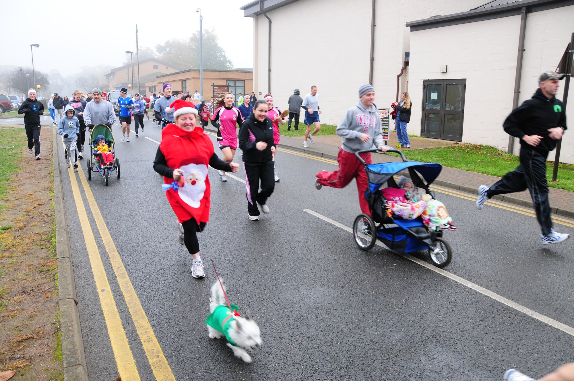 ROYAL AIR FORCE LAKENHEATH, England – Team Lakenheath members run past the starting line of the 2010 Turkey Trot at the fitness center Nov. 20. The fitness center donated turkeys and pies to be raffled off and given to each categories first and second place winners. (U.S. Air Force photo/Senior Airman Stephen Linch)