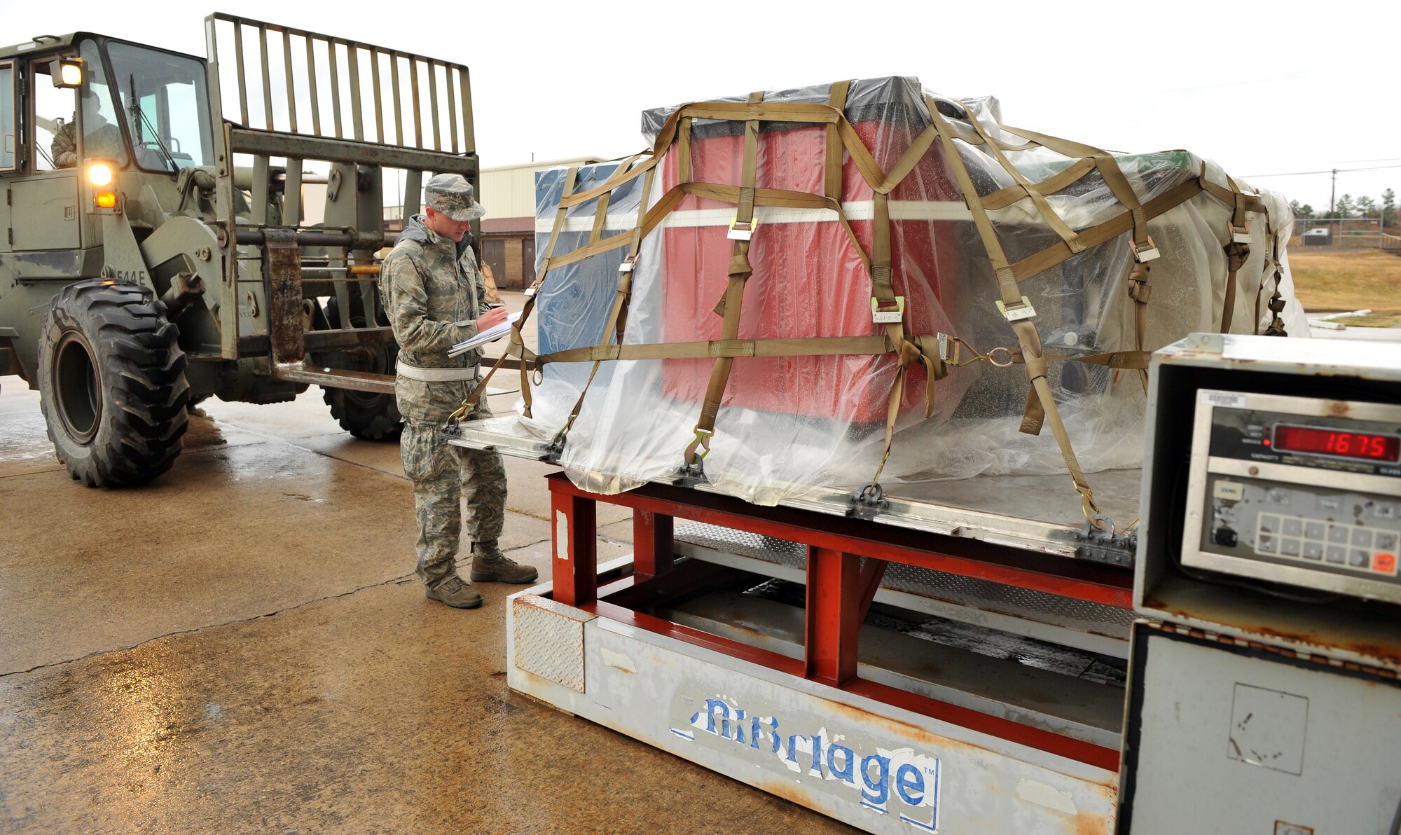 Senior Airman Matthew Geroux, a 19th Logistic Readiness Squadron traffic management journeyman, writes down the weight of cargo Nov. 16, 2010, at Little Rock Air Force Base, Ark. Aerial Porters are responsible for cargo being properly prepared for air shipment and being mission ready. (U.S. Air Force photo by Senior Airman Gul Crockett)