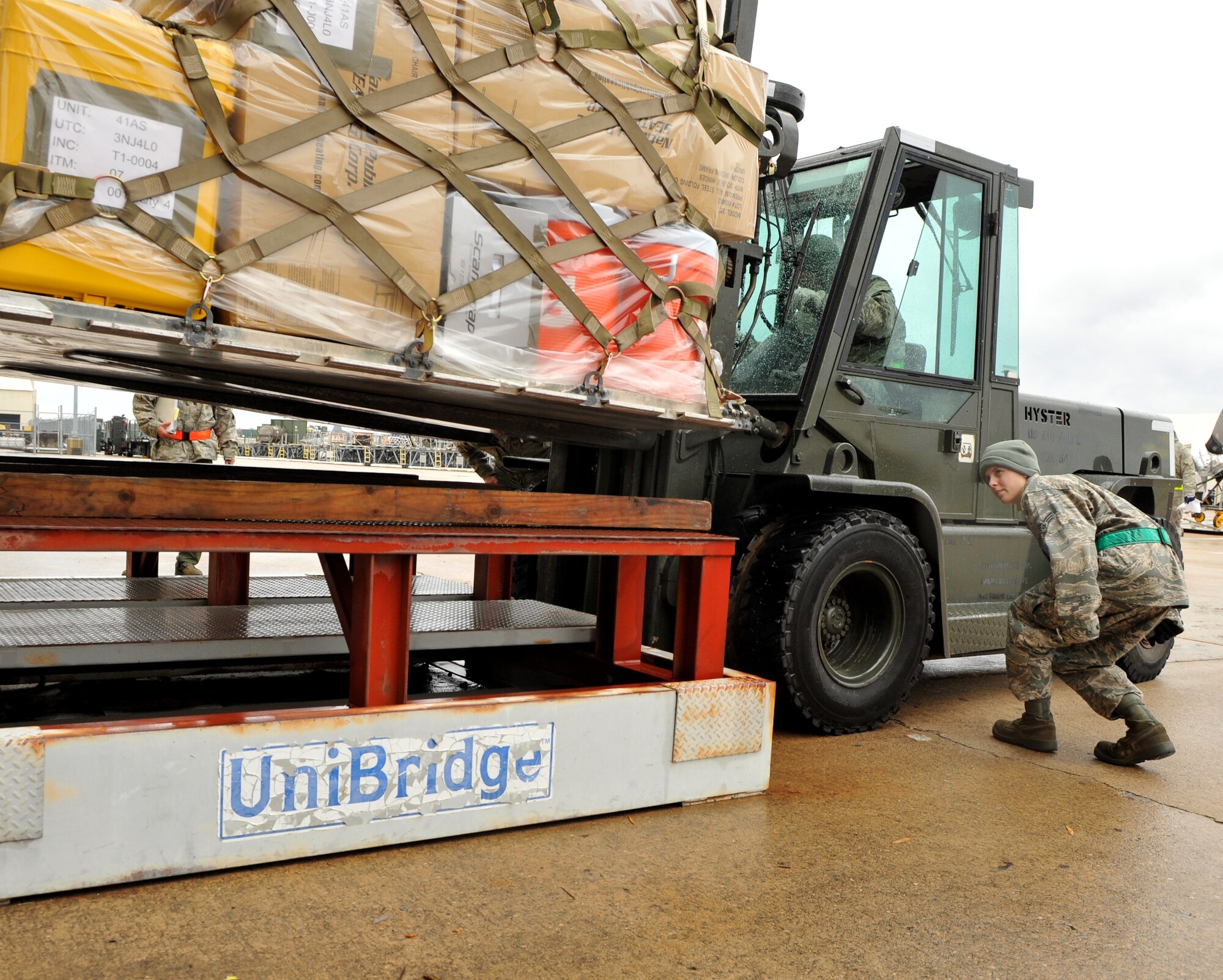 Senior Airman Bobbi Reichert, a 19th Logistic Readiness Squadron vehicle maintenance journeyman, spots Senior Airman Bryan Wails, 19th LRS vehicle maintenance journeyman, as he forklifts cargo on a weight scale Nov. 16, 2010, at Little Rock Air Force Base, Ark.  Aerial Porters are responsible for cargo being properly prepared for air shipment and being mission ready. (U.S. Air Force photo by Senior Airman Gul Crockett)