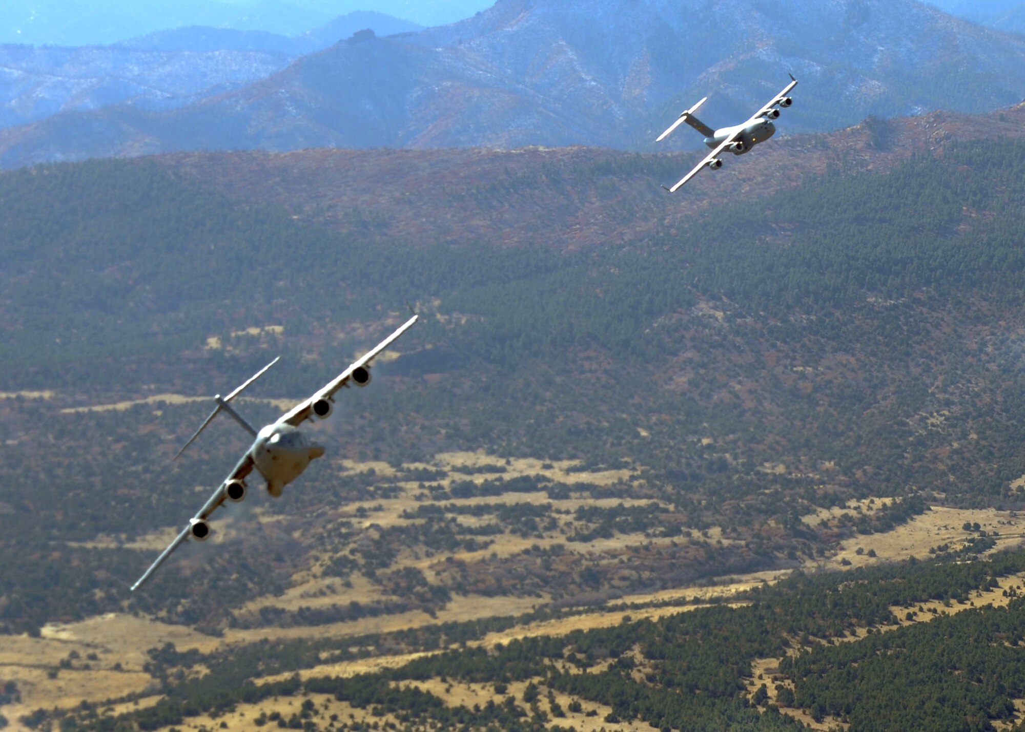 Two C-17 Globemaster IIIs move into formation during a Mobility Air Force Exercise Nov. 17, 2010, near Nellis Air Force Base, Nev. The MAFEX is a biannual, Air Force-wide training opportunity hosted by the Air Force Weapons School there. (U.S. Air Force photo/ Airman 1st Class Myles Stepp)