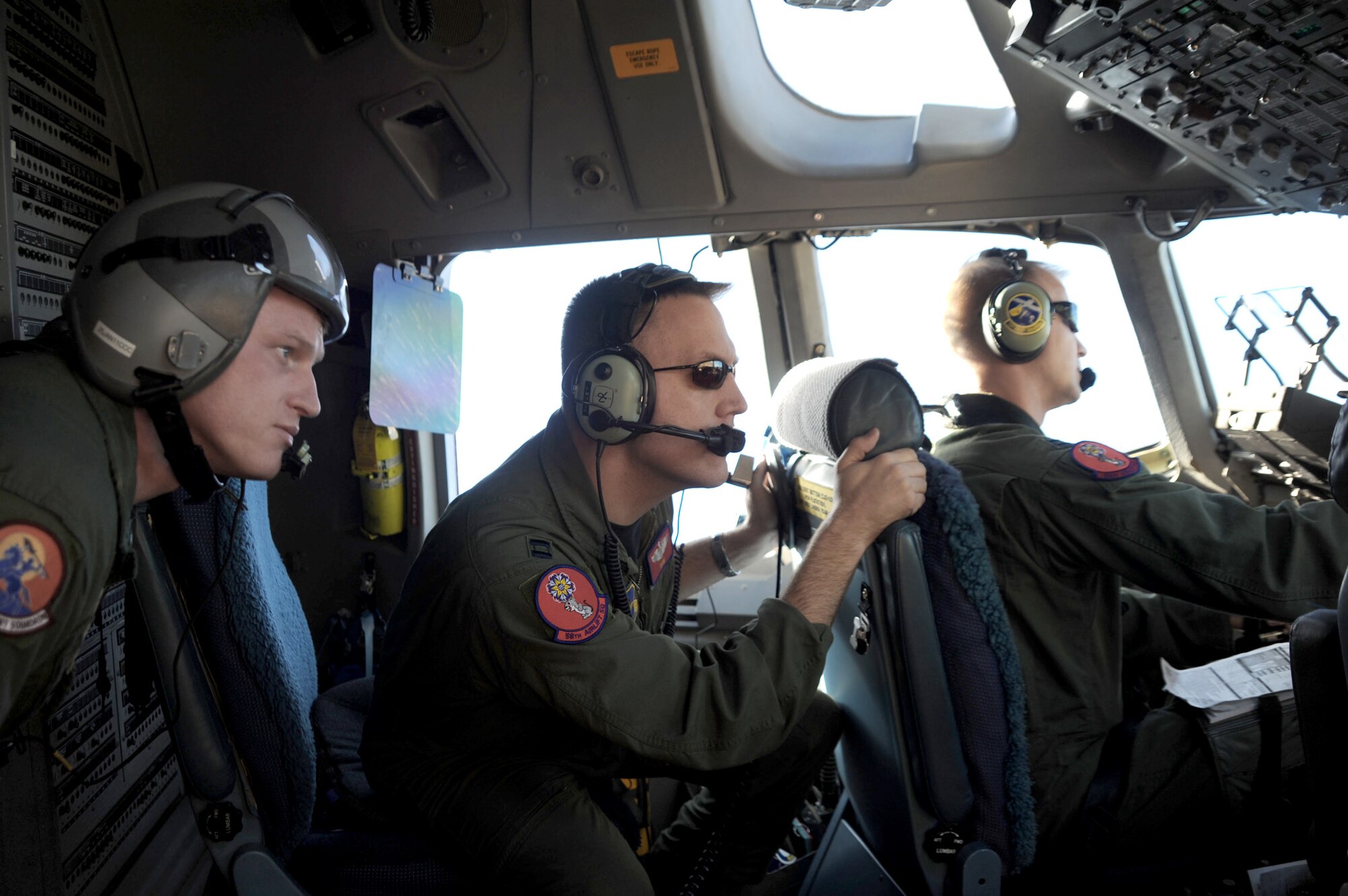 Tech. Sgt. Chad Turner (from left), Capt. Bryan Bailey, and Capt. Ryan Goodlin search for simulated surface-to-air missles during a Mobility Air Force Exercise Nov 18, 2010, near Nellis AFB, Nevada. The MAFEX is a bi-annual, Air Force-wide training opportunity hosted by the Air Force Weapons School there. The three Airmen are from the 58th Airlift Squadron. (U.S. Air Force photo/Airman 1st Class Myles Stepp)