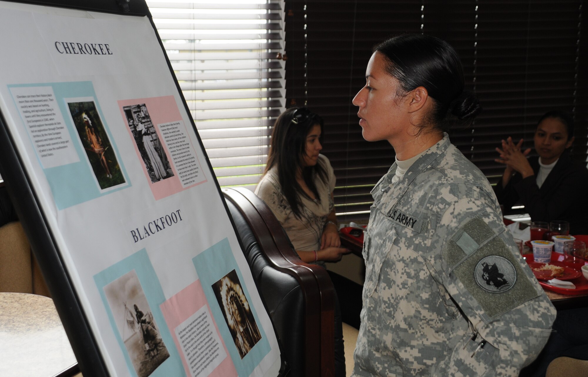SOTO CANO AIR BASE, Honduras --  Staff Sgt. Raquel Martinez, of the Army Forces here, reads a brief history of the Cherokee tribe during the Native America Heritage Luncheon at the dining facility here Nov. 17. The heritage celebration month, which has taken place every November since 1994, can be traced back to the early 20th century. At that time, Native Americans first began an effort to gain a day of recognition for the significant contributions the first Americans made to the establishment and growth of the U.S. (U.S. Air Force photo/Tech. Sgt. Benjamin Rojek)
