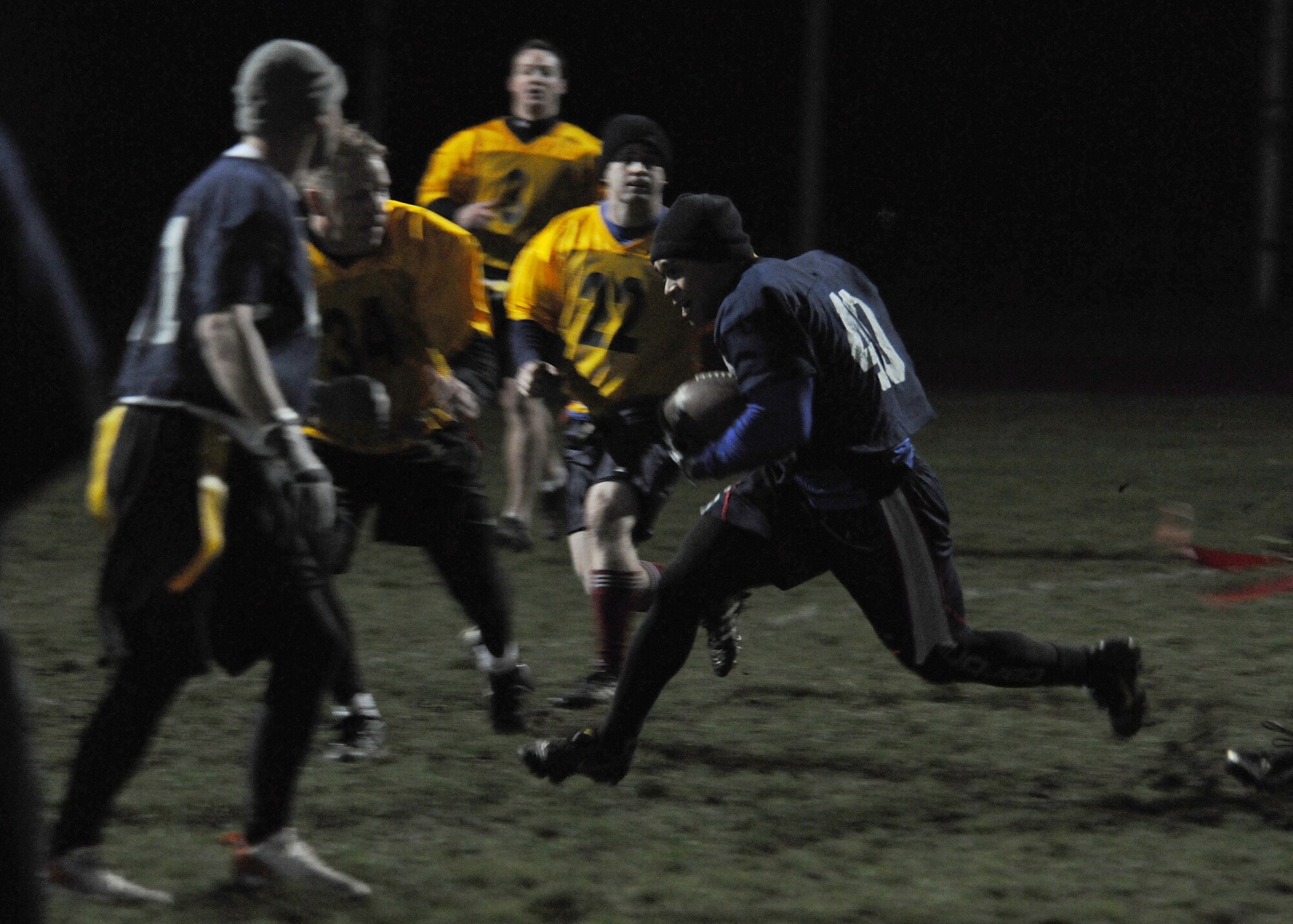 RAF MILDENHALL, England -- Lancaster Ladore, 488th Intelligence Squadron, gains yards here Nov. 18, 2010, during the intramural football championship.  The 488th IS beat the 100th Operations Group, 12-6.  Intramural football, organized by the 100th Force Support Squadron fitness staff, helps build the moral of base members.  (U.S. Air Force photo/Senior Airman Tabitha M. Lee)