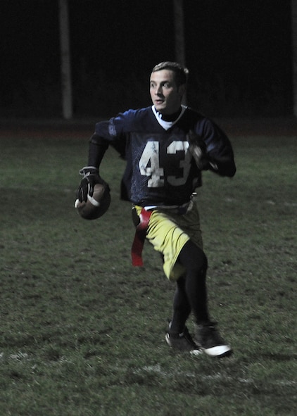 RAF MILDENHALL, England -- Samual McKee, 95th Reconnaissance Squadron, searches for a receiver here Nov. 18, 2010, during the intramural football championship.  The joint 95th RS and 488th Intelligence Squadron team beat the 100th Operations Group, 12-6.   Intramural football, organized by the 100th Force Support Squadron fitness staff, helps build the moral of base members.  (U.S. Air Force photo/Senior Airman Tabitha M. Lee)  