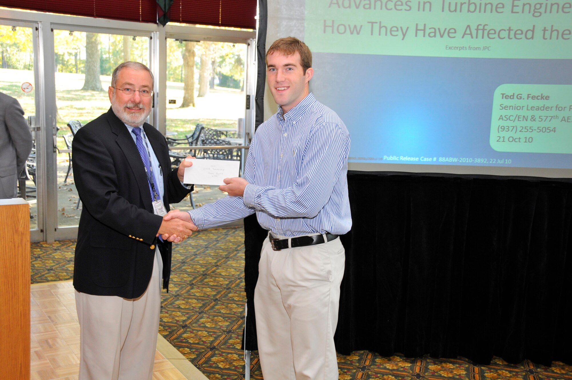 Tom Best, AEDC’s director of engineering and technical management, presents an ITEA scholarship check to James Rogers, a second year graduate student at the University of Tennessee Space Institute (UTSI). The occasion was a lunch and learn event sponsored by the Arnold Association of Professional Societies at the Arnold Lakeside Center Oct. 20, 2010. (Photo by Rick Goodfriend)