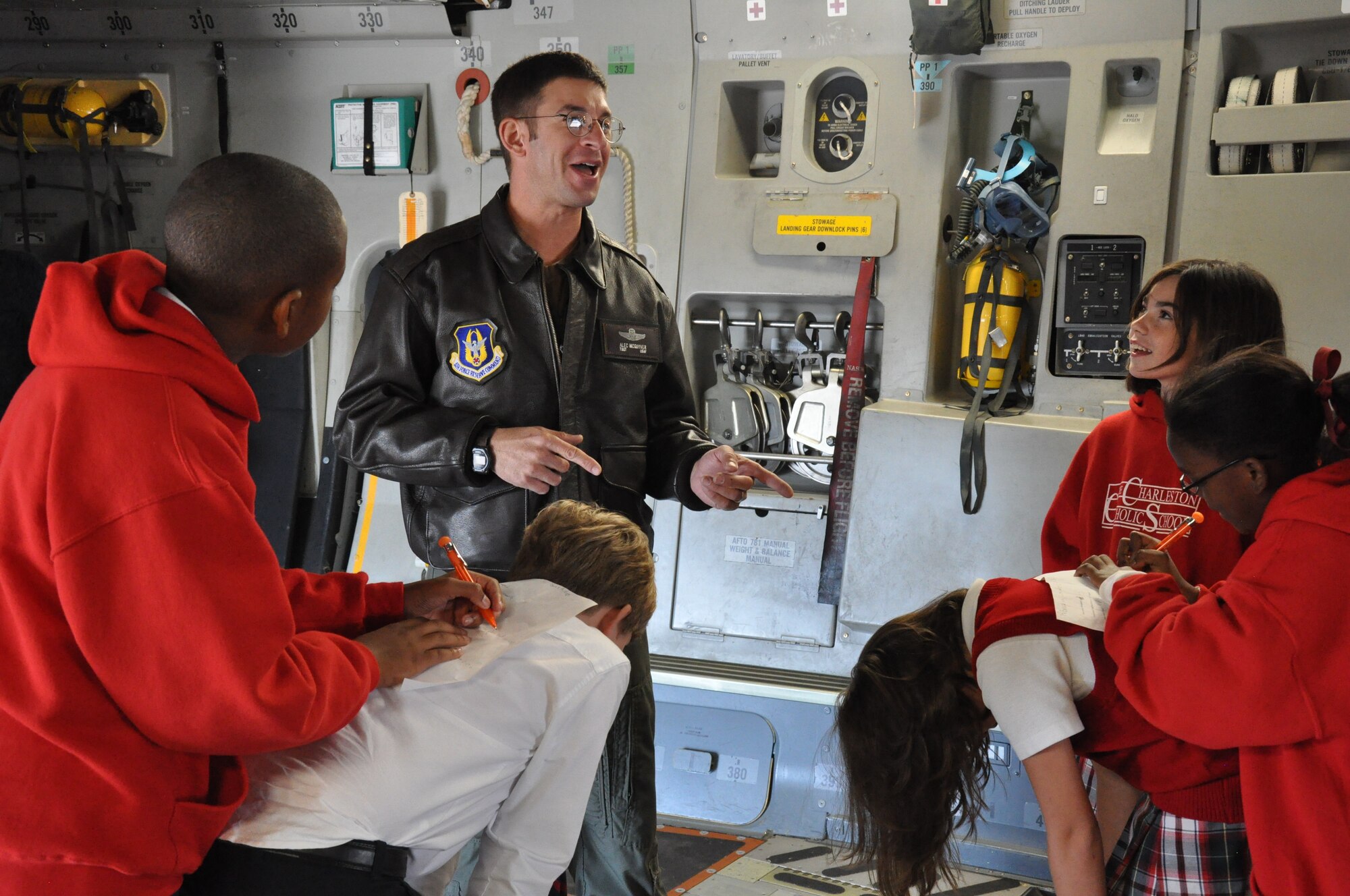 Tech. Sgt. Alec R. McGuyver, a loadmaster with the 317th Airlift Squadron, quizes students from The Charleston Catholic School during a static tour of a C-17 Globemaster III aircraft during their visit to Joint Base Charleston, S.C. Nov. 19, 2010. (U.S. Air Force photo/Airman 1st Class Robert Pilch)