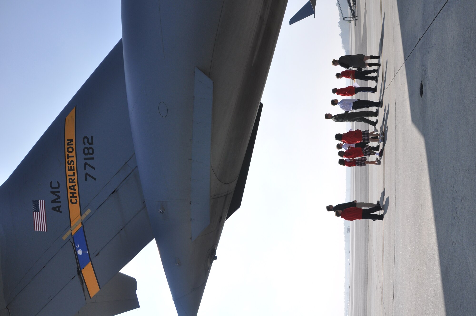 Lt. Col. John B. Gurrieri, a pilot with the 300th Airlift Squadron, leads students from The Charleston Catholic School around the tail section of a C-17 Globemaster III aircraft during their tour of Joint Base Charleston, S.C. Nov. 19, 2010. (U.S. Air Force photo/Airman 1st Class Robert Pilch)