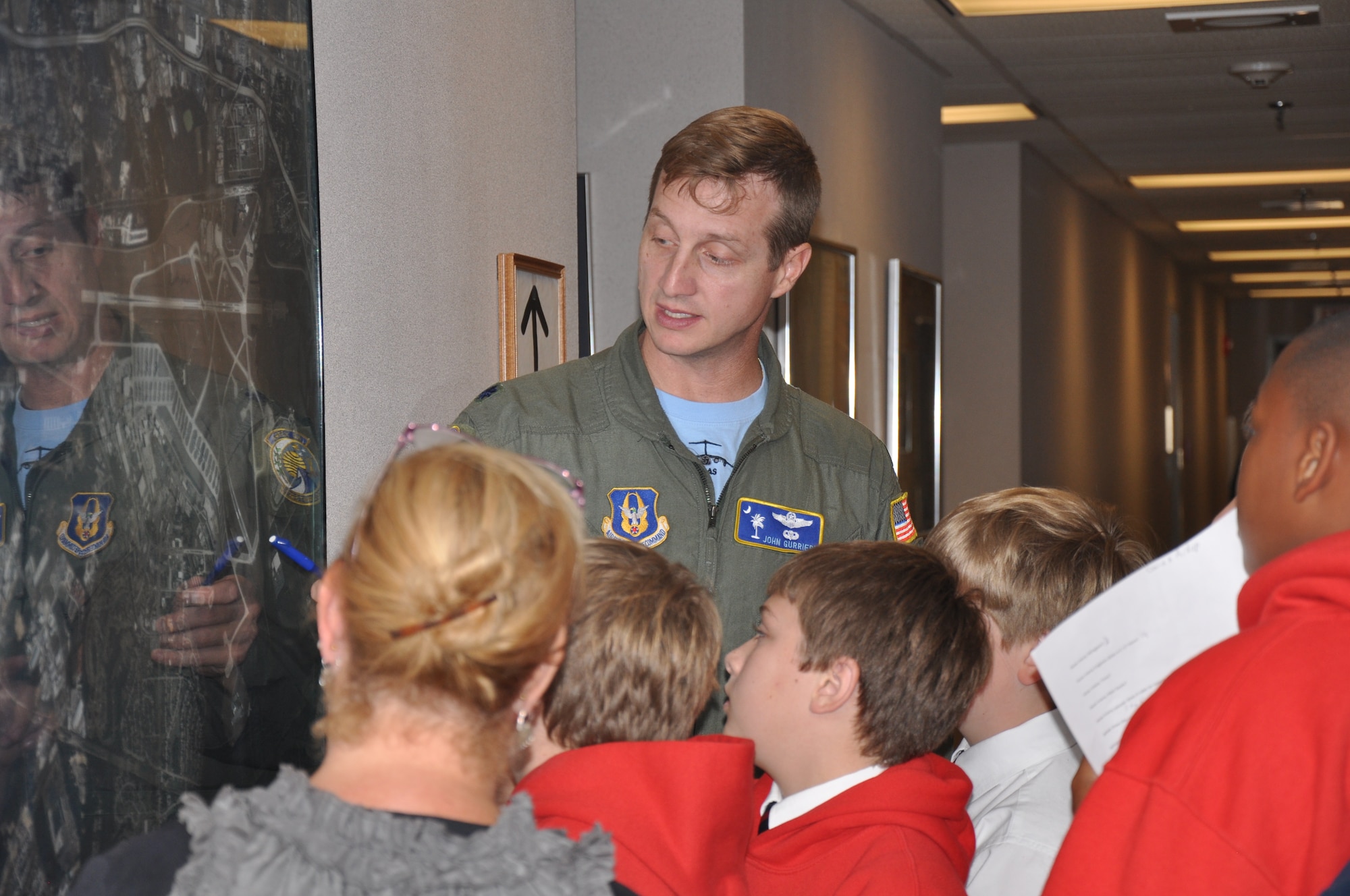 Lt. Col. John B. Gurrieri, a pilot with the 300th Airlift Squadron, shows students from The Charleston Catholic School an aerial map of Joint Base Charleston, S.C. as they tour base facilities during their visit Nov. 19, 2010. (U.S. Air Force photo/Airman 1st Class Robert Pilch)