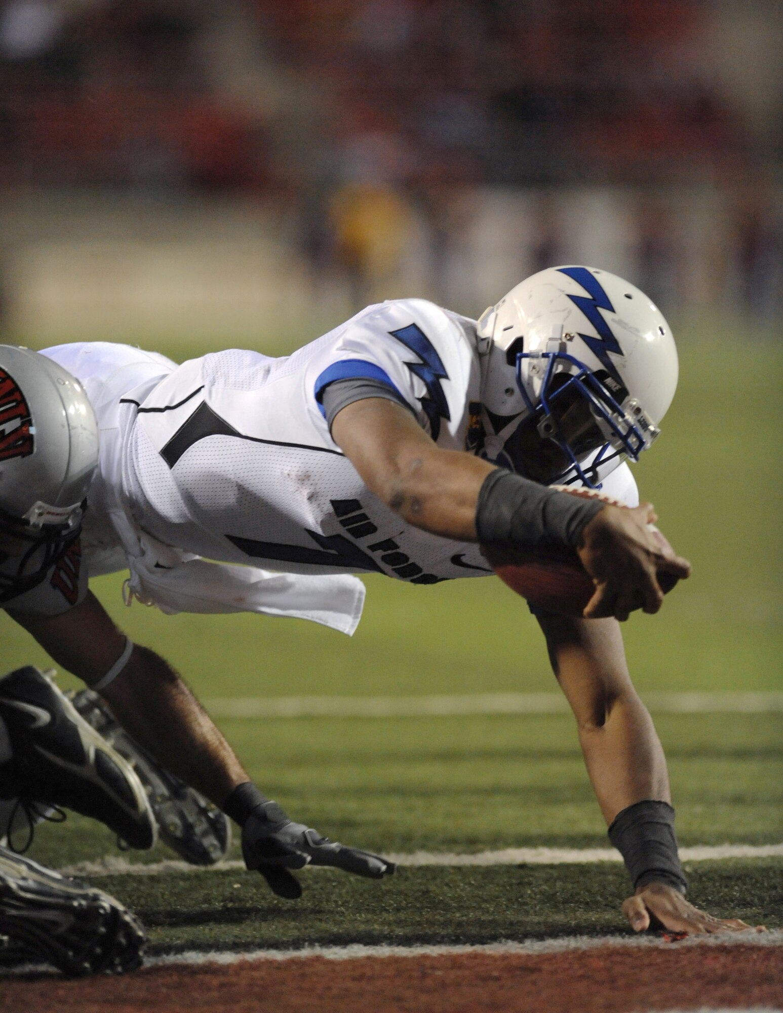 Air Force quarterback Tim Jefferson dives into the end zone for a touchdown in the Falcons' final game of the regular season against UNLV in Las Vegas Nov. 18, 2010. Jefferson, a native of Atlanta, threw for 111 yards and ran for 64, scoring three rushing touchdowns to lead the Falcons to a 35-20 victory over the Rebels. (U.S. Air Force photo/Airman 1st Class Daniel Hughes)