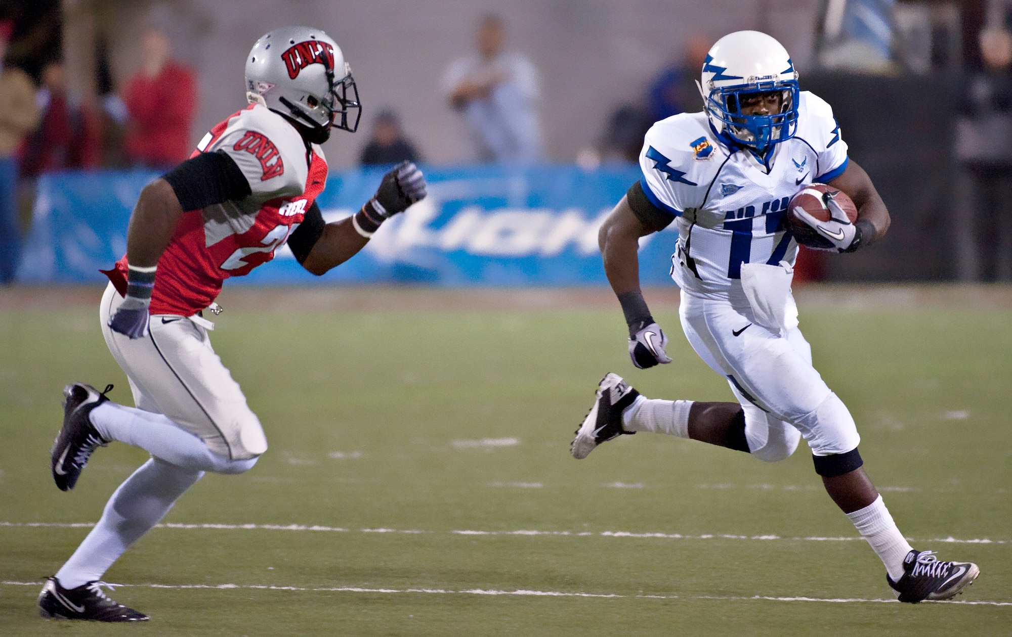 Air Force running back Asher Clark runs left during the Falcons' match against UNLV in Las Vegas Nov. 18, 2010. Clark, a native of Lawrenceville, Ga., had 14 rushes and 82 yards, which puts him over 1,000 yards for the season. The Falcons defeated the Rebels 35-20 in their final regular-season game, improving their record to 8-4. (U.S. Air Force photo/Tech. Sgt. Michael R. Holzworth)