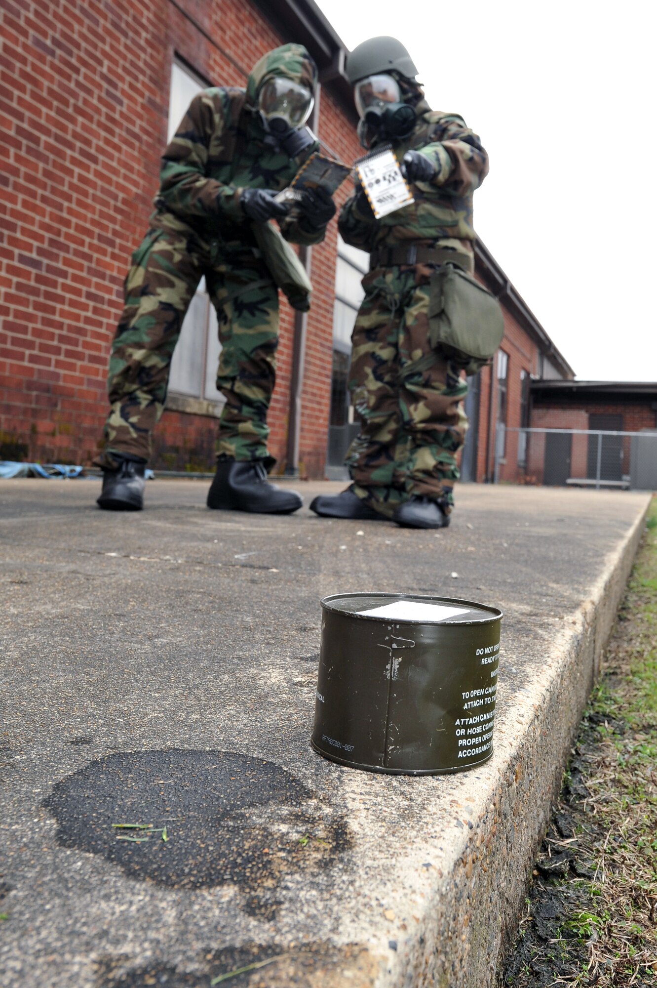Staff Sgt. Nestor Cruz and Staff Sgt. Malik Buchanan, both from the 19th Airlift Wing, turn to their Airman's manuals to identify a partial unexploded ordnance during ATSO training Nov. 18, 2010, at Little Rock Air Force Base, Ark. Members of the 19th Airlift Wing prepare for inspections like the upcoming Operational Readiness Inspection by honing their skills during base exercises. (U.S. Air Force photo by Staff Sgt. Chris Willis)