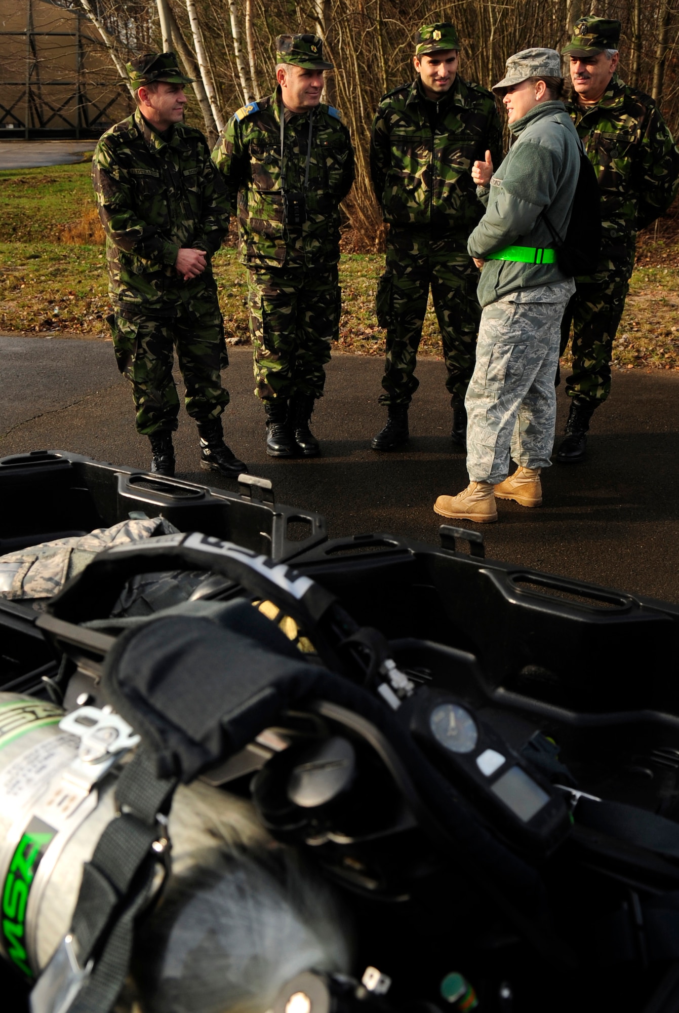 U.S. Air Force Staff Sgt. Rebecca Tongen a Silver Flag Cadre, briefs members of the Romanian air force on the particulars of the Chemical, Biological, Radiological, and Nuclear training station, during the practical exercise of Silver Flag, Ramstein Air Base, Germany, Nov. 20, 2010. Silver flag is a weeklong, ongoing training program that combines classroom and practical application exercises to prepare Airmen for deployment scenarios. Members of the Romanian air force were invited to observe training and share information, to develop integrated solutions, so that they can take the information back and implement some of the same principals to their own forces' training.  (U.S. Air Force Photo by Tech Sgt. Jocelyn Rich)