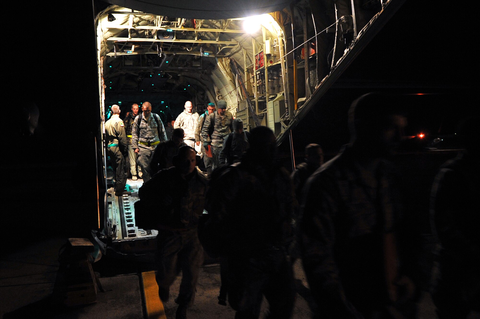 Airmen exit a C-130 aircraft on their way to Camp Warlord Training Facility Nov. 17, 2010, during the RockEx exercise at Little Rock Air Force Base, Ark. Members of the 19th Airlift Wing prepare for inspections like the upcoming Operational Readiness Inspection by honing their skills during base exercises. (U.S. Air Force photo by Staff Sgt. Chris Willis)
