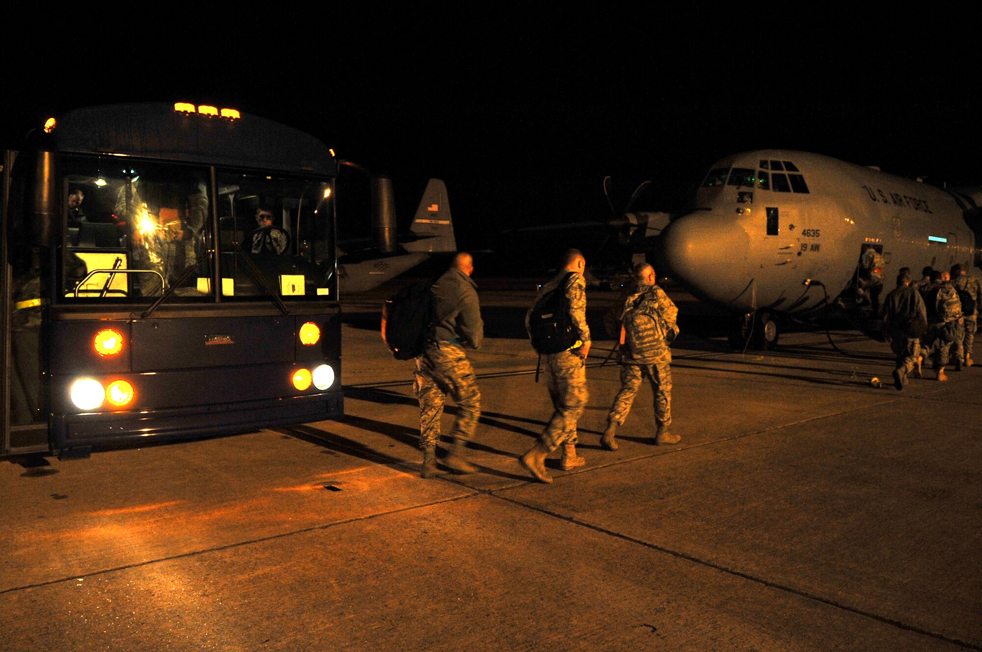 Airmen transfer from a bus to a waiting C-130 aircraft Nov. 17, 2010, during the RockEx exercise at Little Rock Air Force Base, Ark. Members of the 19th Airlift Wing are preparing for the upcoming Operational Readiness Inspection by honing their skills with a base Operation’s Readiness Exercise. (U.S. Air Force photo by Staff Sgt. Chris Willis)