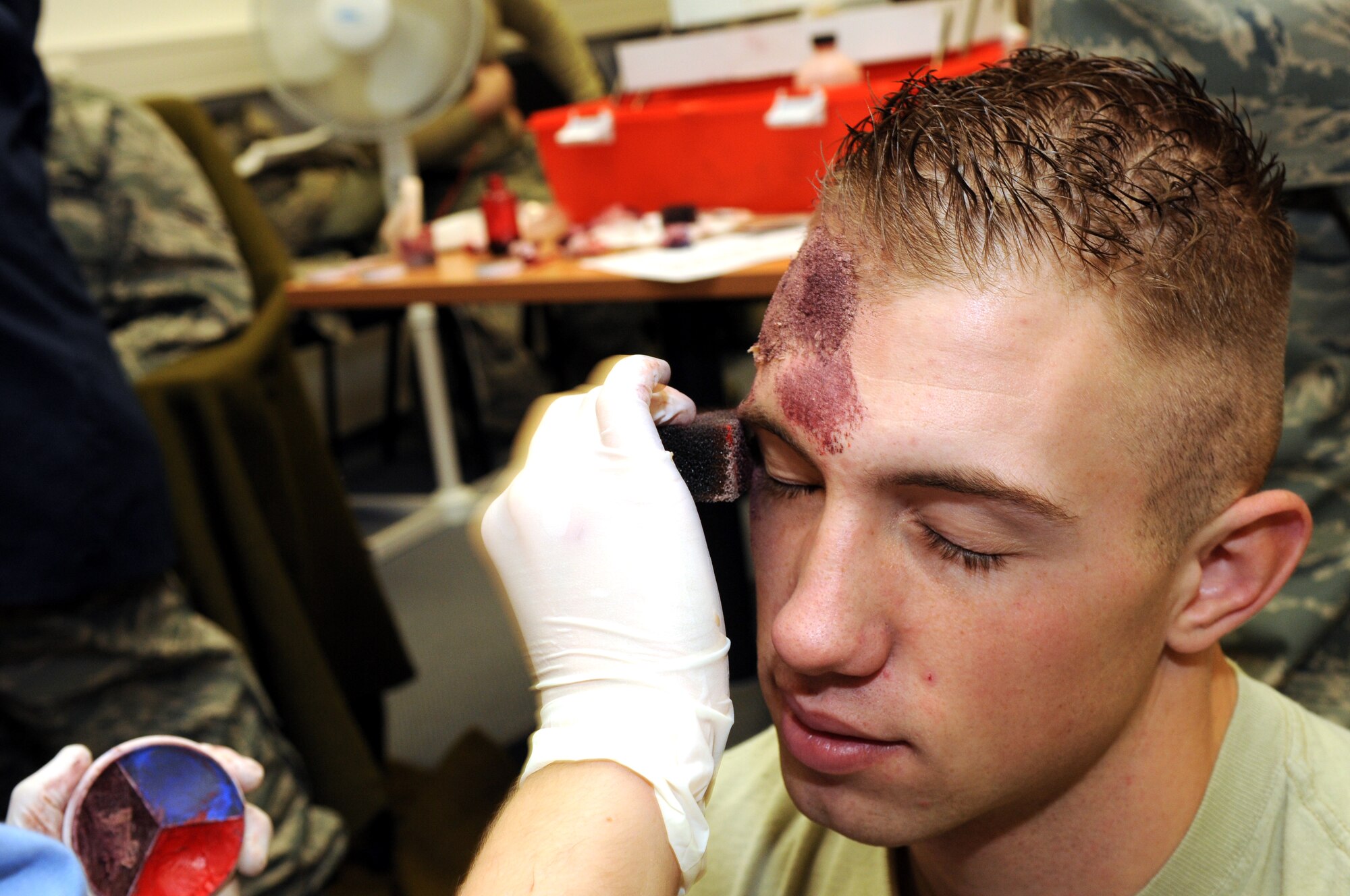 SPANGDAHLEM AIR BASE, Germany –Airman 1st Class Joshua McMillan, 52nd Mission Support Group, has moulage applied to his forehead in preparation for an emergency response exercise Nov. 16. The exercise evaluated the wing’s response to an incident including hazardous chemical exposure. (U.S. Air Force photo/Airman 1st Class Matthew B. Fredericks)