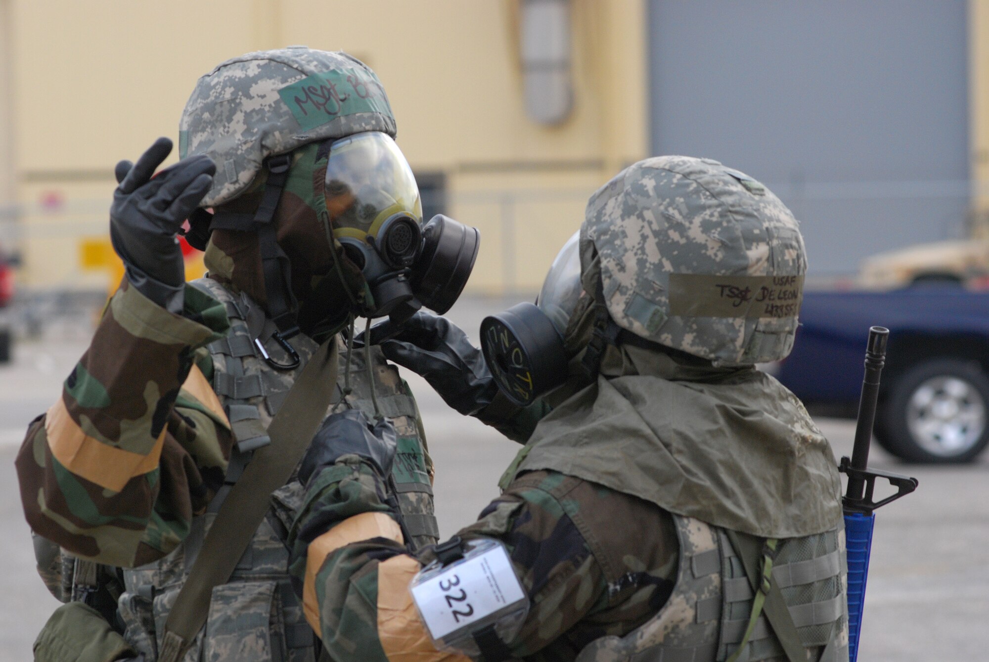 The 433rd Airlift Wing at Lackland Air Force Base, Texas, during the operational readiness exercise for November 2010. Alamo Wing Airmen were tested on disaster and attack preparedness under different conditions and different force protection protocols. Tech. Sgt. Jesus Leleon Gurerro checks Tech. Sgt. Bailey's gas mask. (U.S. Air Force photo/Airman 1st Class Brian McGloin)