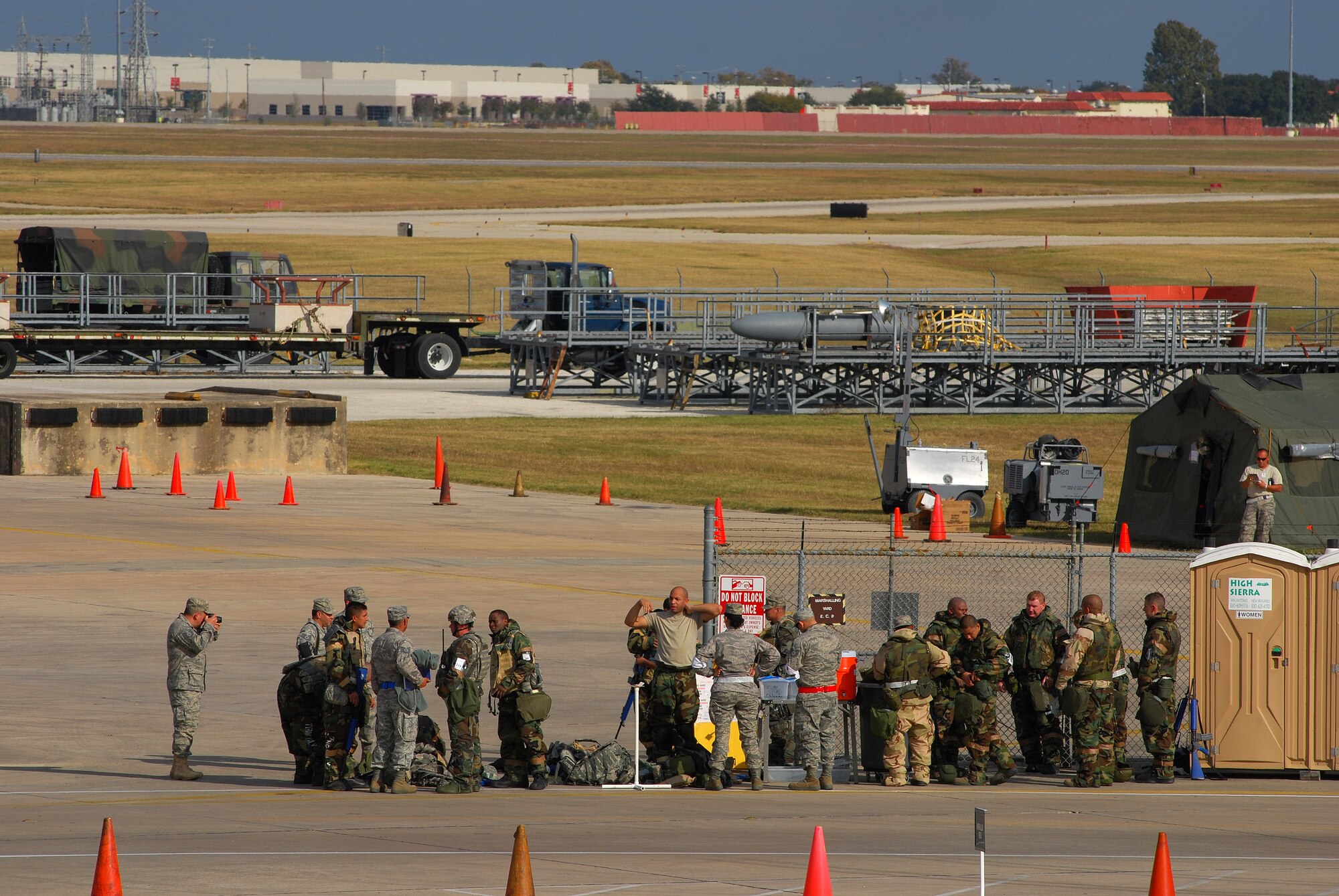 Alamo Wing Airmen were tested during the operational readiness exercise, November 2010, at Lackland Air Force Base, Texas, on disaster and attack preparedness under different conditions and different force protection protocols. These Airmed were ready for relaxing and removing mission oriented personal protective equipment after the exercise ended for the day. (U.S. Air Force photo/Airman 1st Class Brian McGloin)